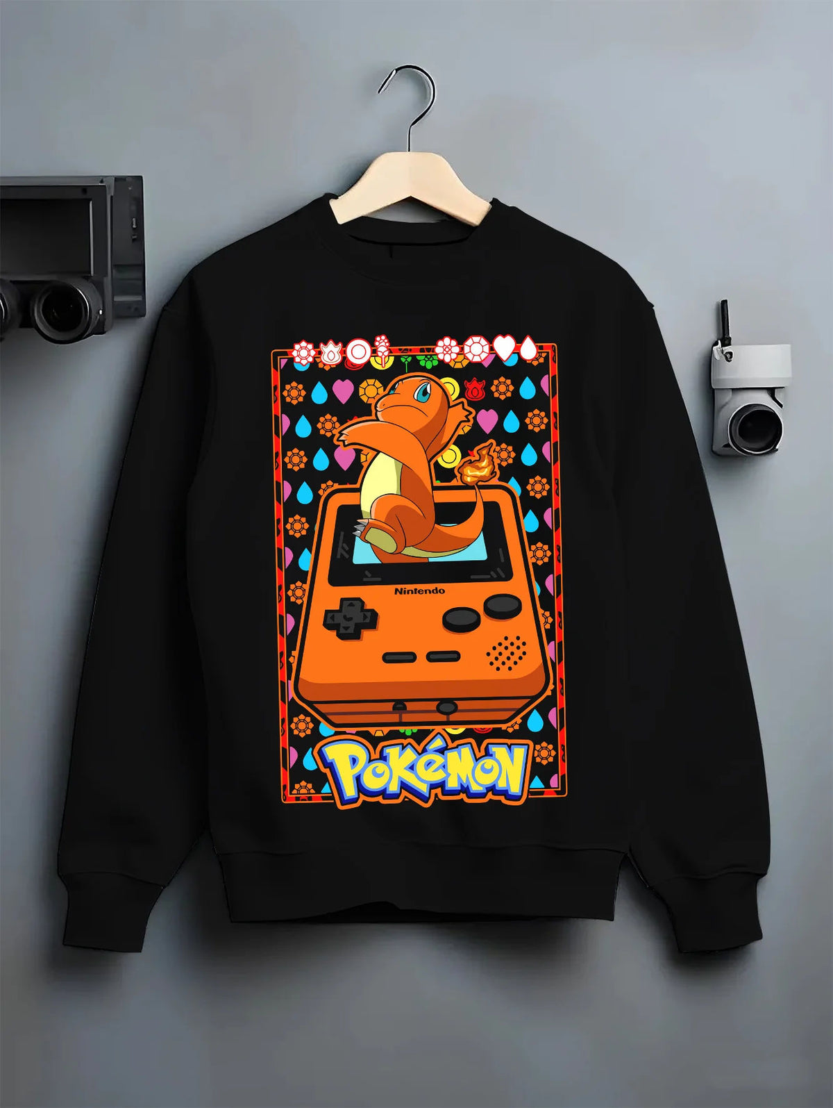 Black crewneck sweatshirt on hanger showing Charizard from Pokémon: retro Game Boy illustration