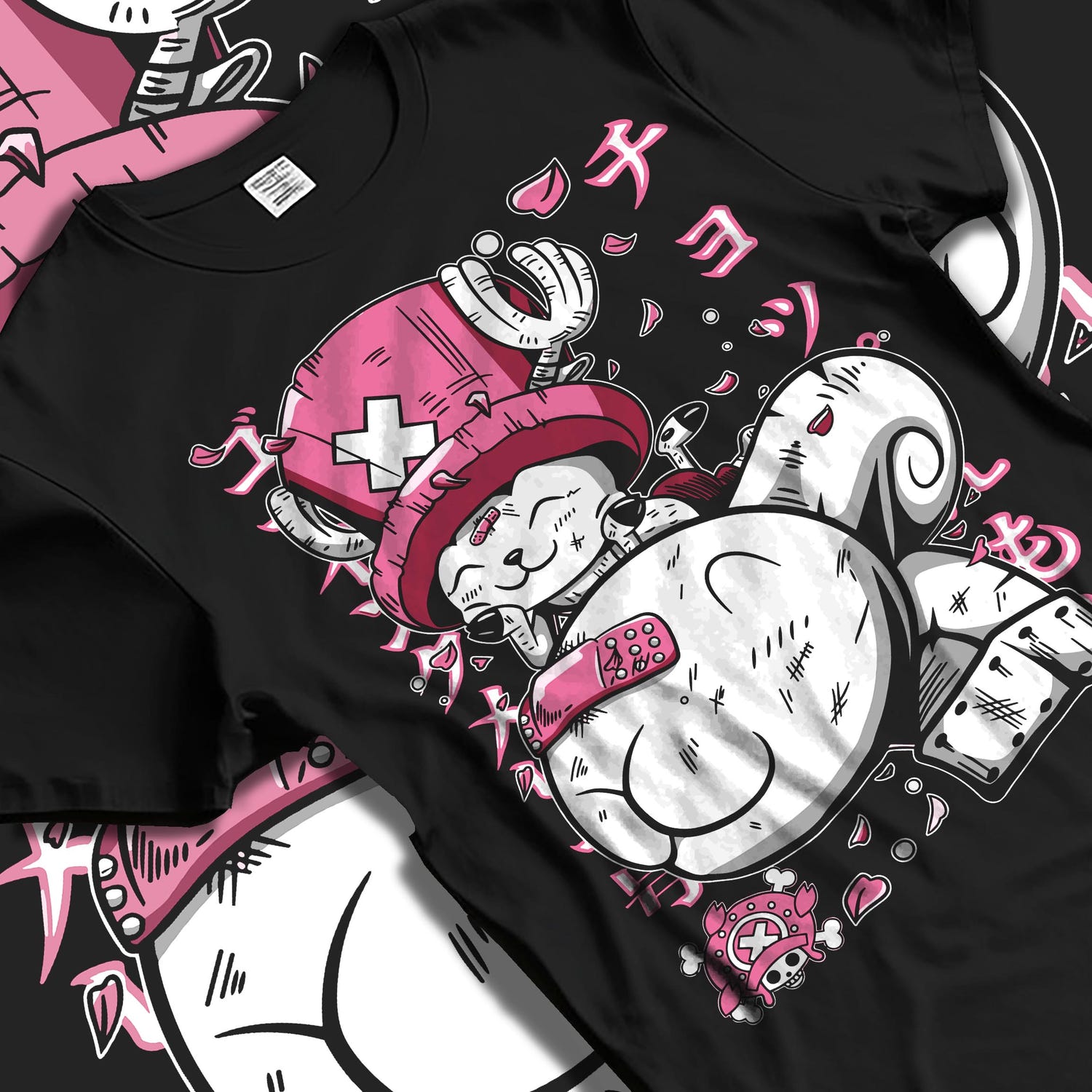 Black T-shirt laid flat with natural fabric folds, featuring One Piece Tony Tony Chopper anime inspired pink and white playful manga graphic design.