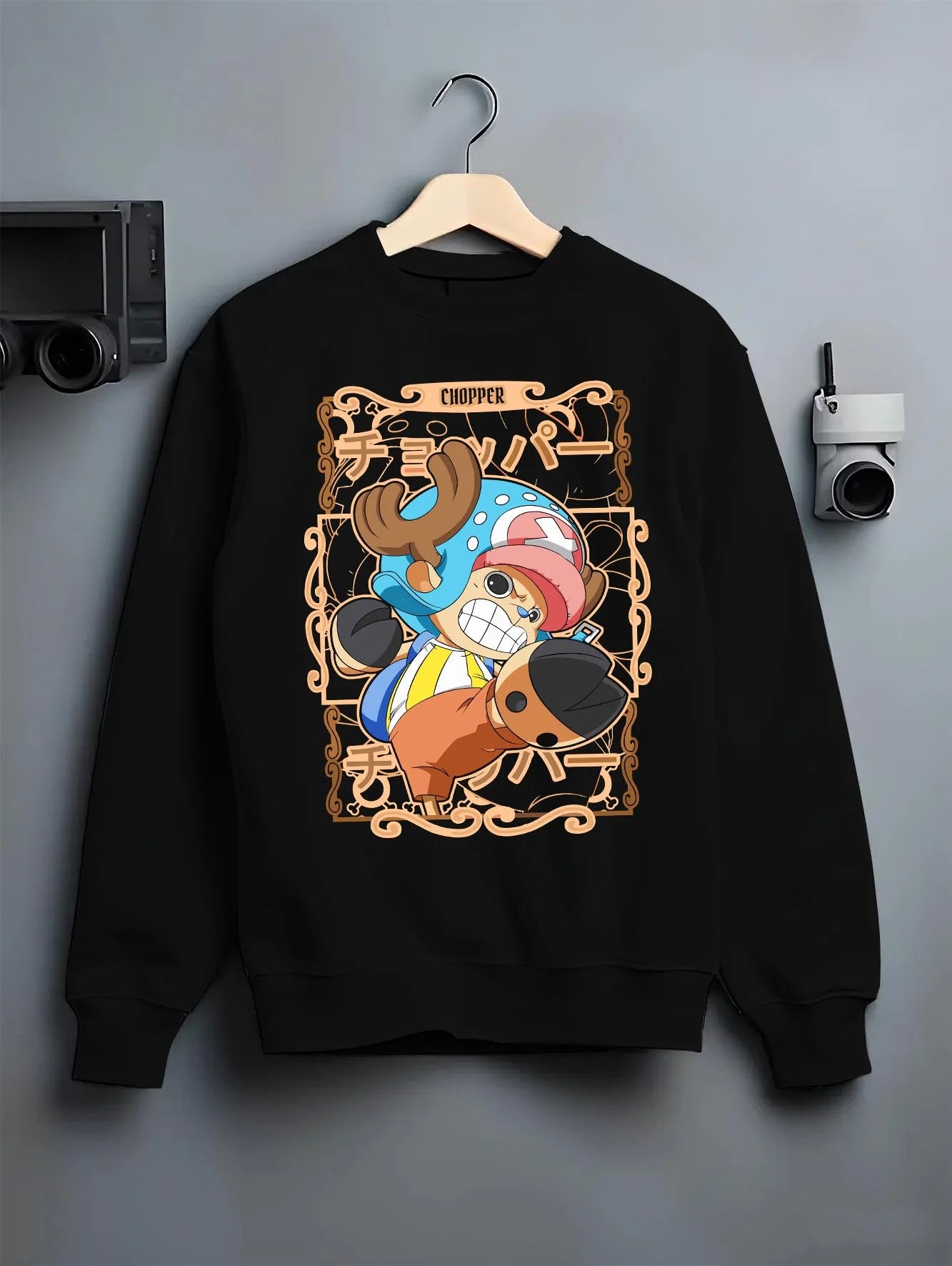 Black crewneck sweatshirt on hanger with Chopper Hoodie One Piece Doctor Small Smirk Panel graphic streetwear graphic.