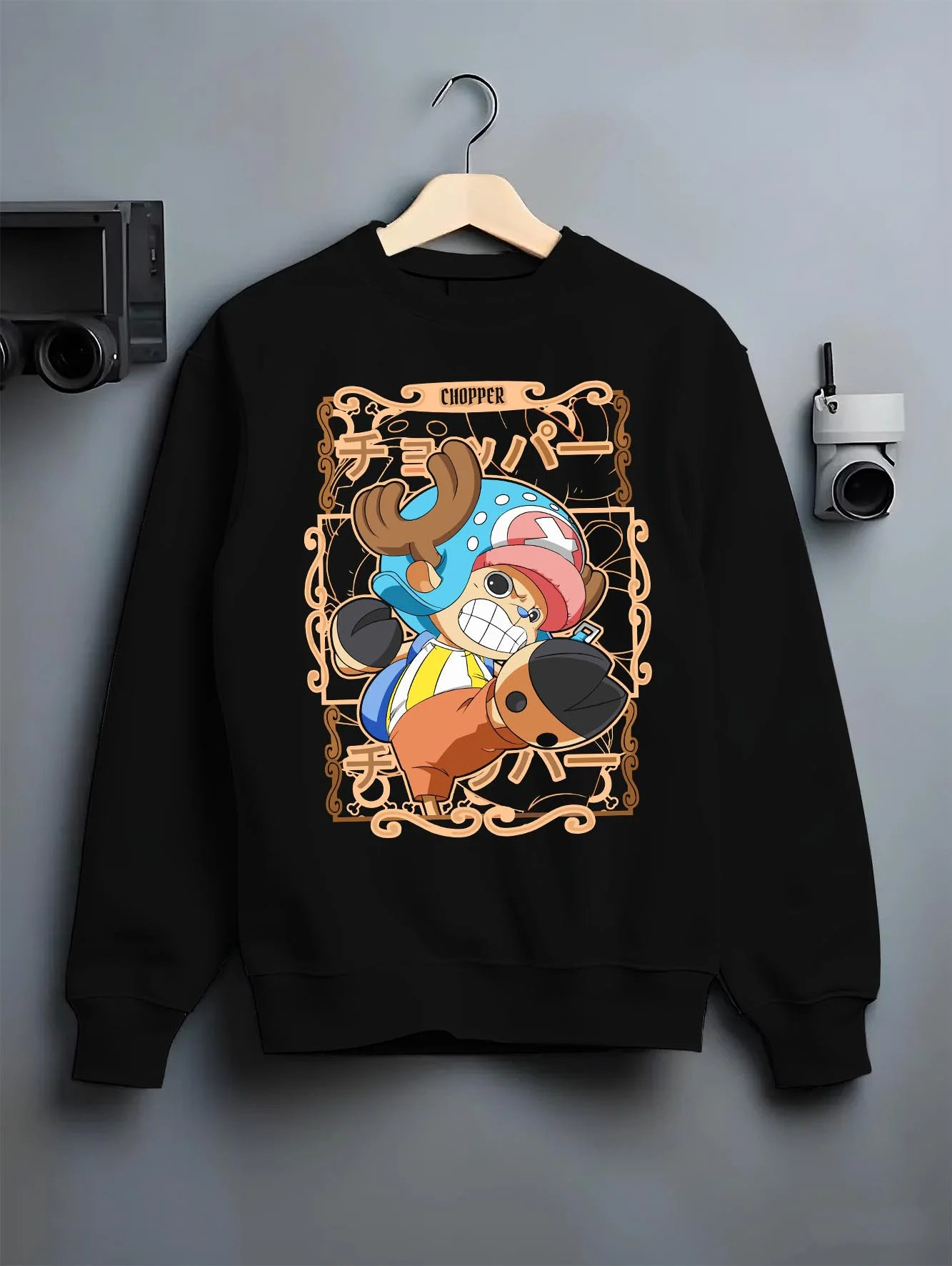 Black crewneck sweatshirt on hanger with Chopper Hoodie One Piece Doctor Small Smirk Panel graphic streetwear graphic.