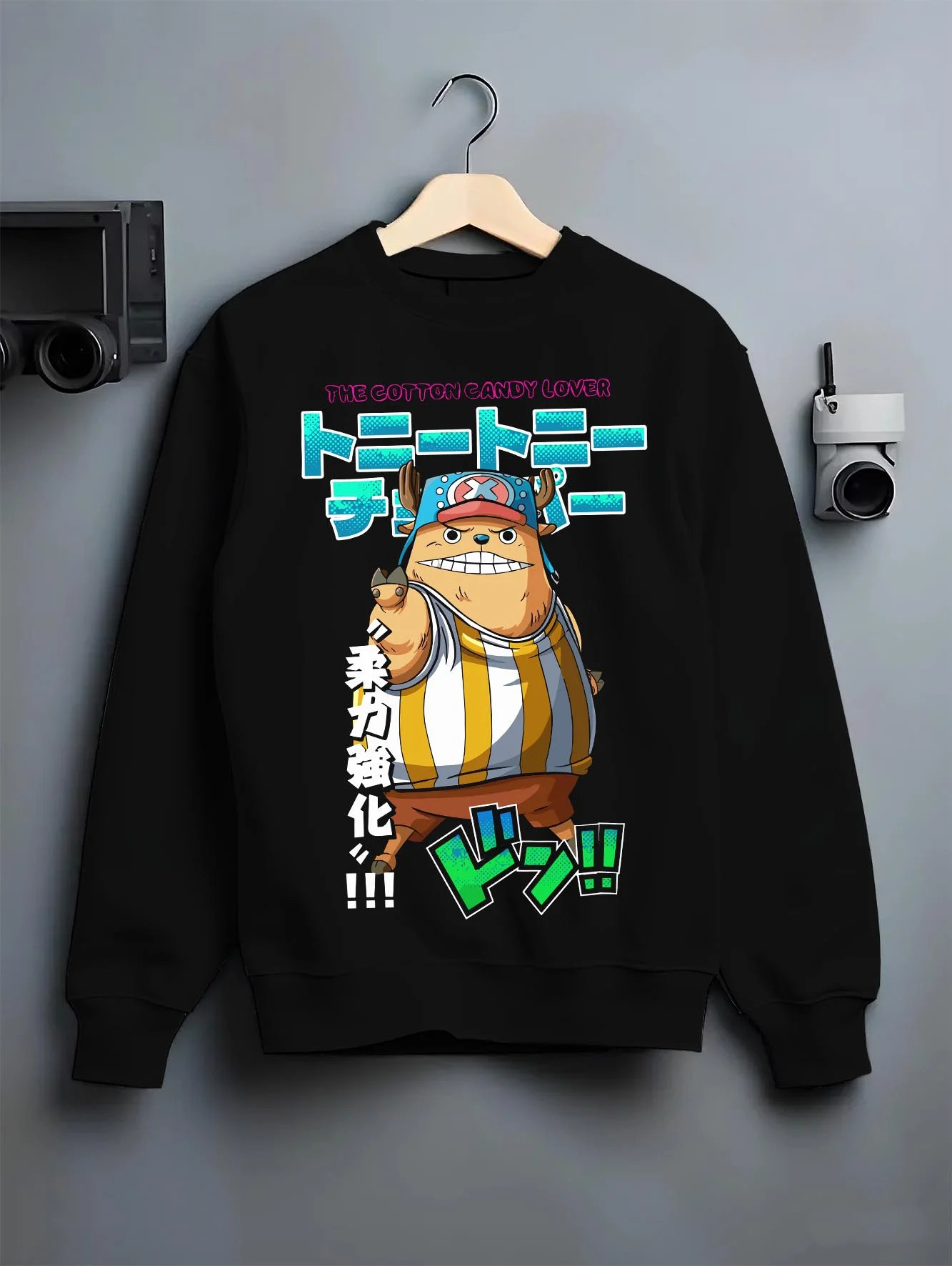 Black crewneck sweatshirt on hanger with Chopper Hoodie One Piece Pirate Straw Hat Crew Hero graphic bold anime graphic.