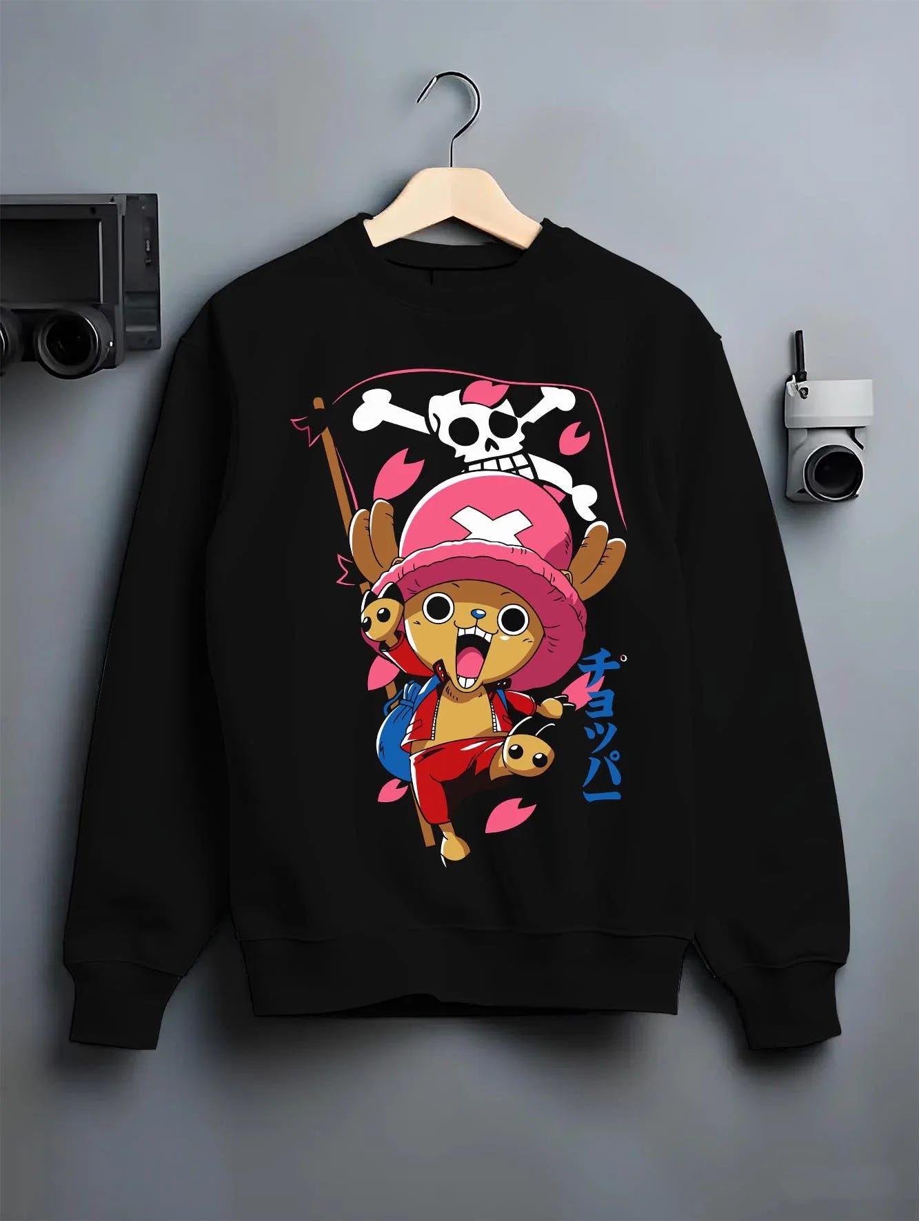 Black crewneck sweatshirt on hanger with Chopper Hoodie One Piece Doctor Pink Hat Skull Mark graphic streetwear graphic.