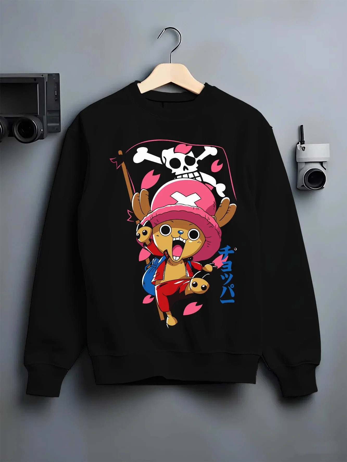 Black crewneck sweatshirt on hanger with Chopper Hoodie One Piece Doctor Pink Hat Skull Mark graphic streetwear graphic.