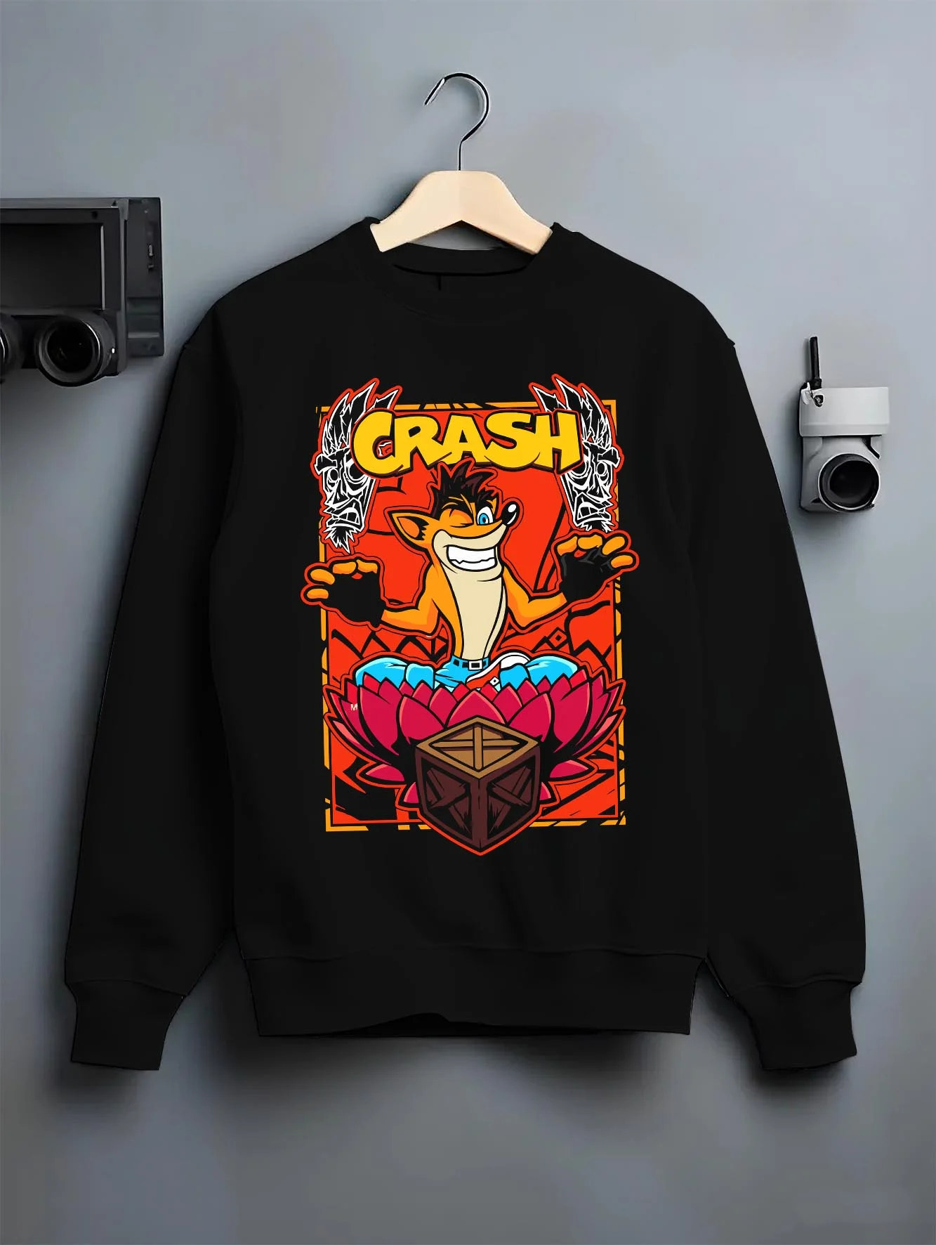 Black crewneck sweatshirt on hanger with Crash Bandicoot Hoodie Retro Gamer 90s Cartoon Print graphic premium wear.