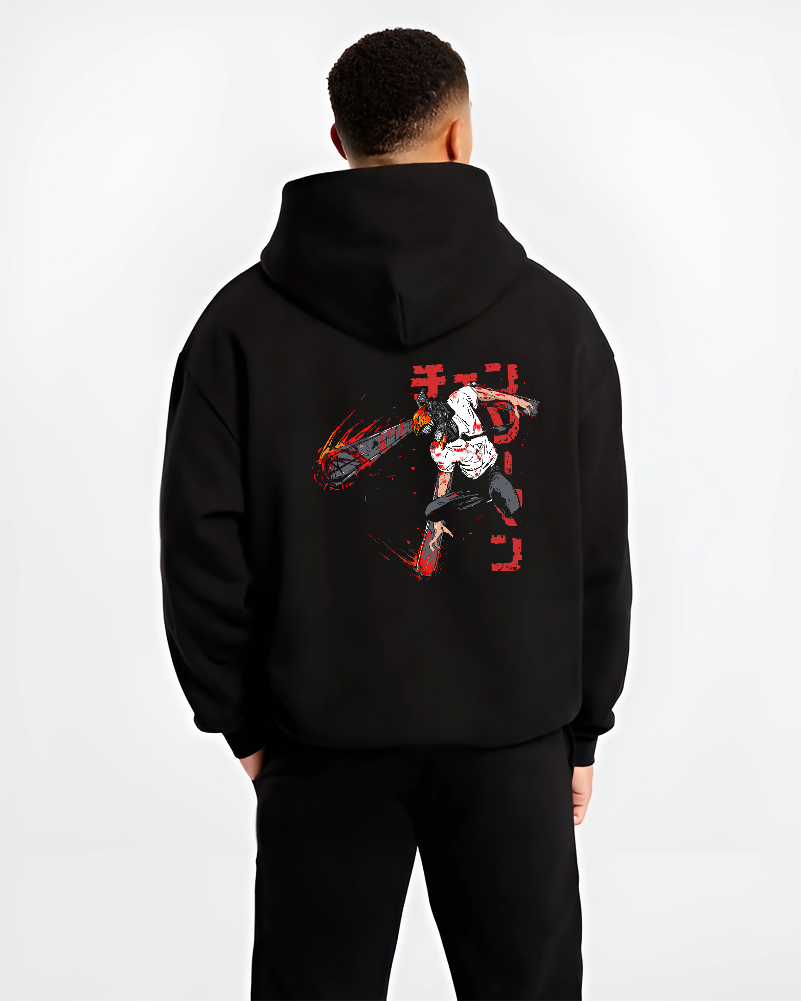 Black hoodie worn by a male model, back view, featuring Chainsaw Man Denji shonen battle character artwork in retro manga aesthetic with anime poster inspired design.