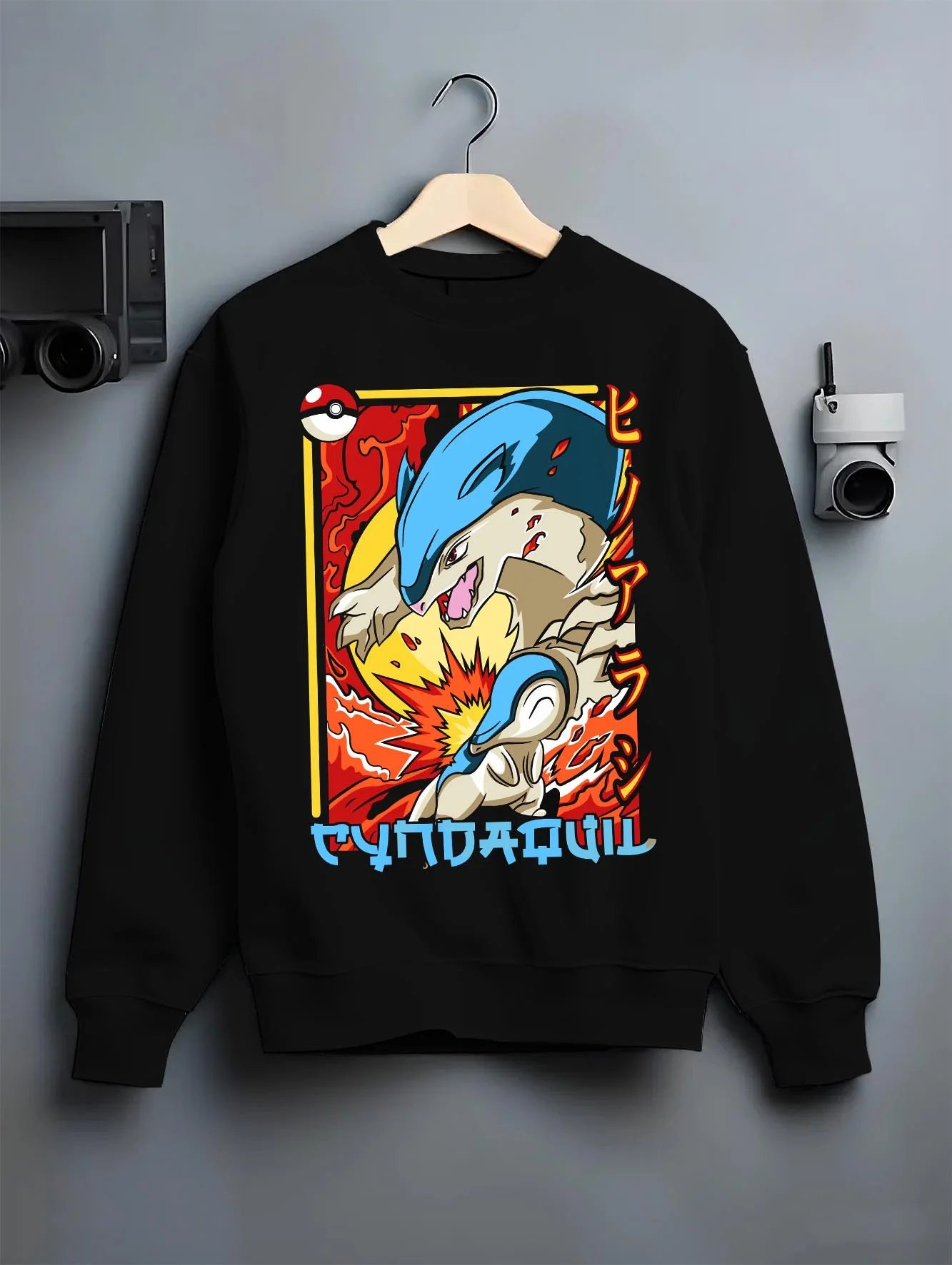 Black crewneck sweatshirt on hanger with Cyndaquil Hoodie Pokémon Retro Fire Starter Flame graphic bold anime graphic.