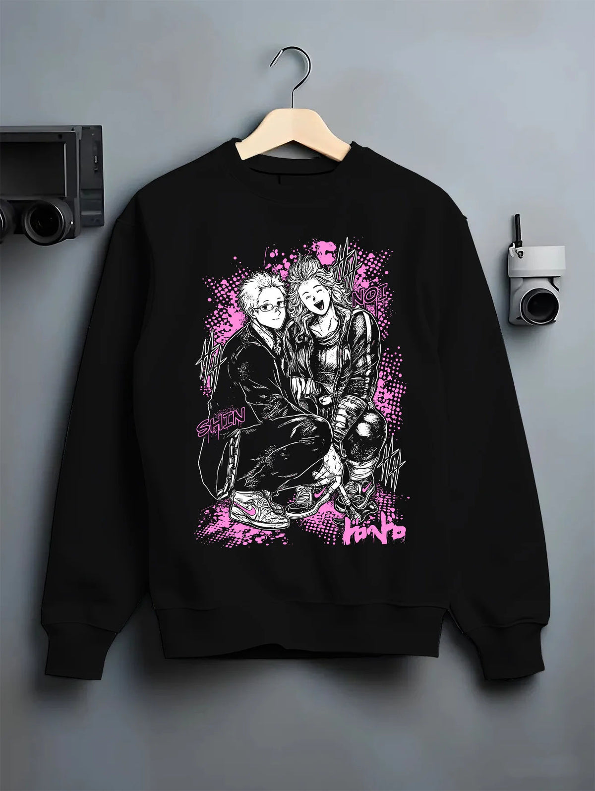 Black crewneck sweatshirt on hanger showing Dandadan: Okarun and Momo duo