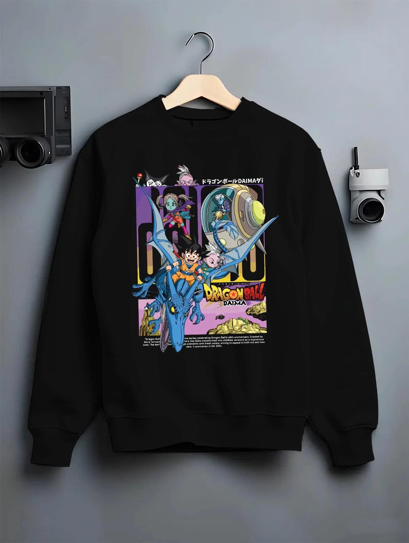 Black crewneck sweatshirt on hanger with Dragon Ball Hoodie Daima Anime Retro Poster Scene graphic Goku anime design.