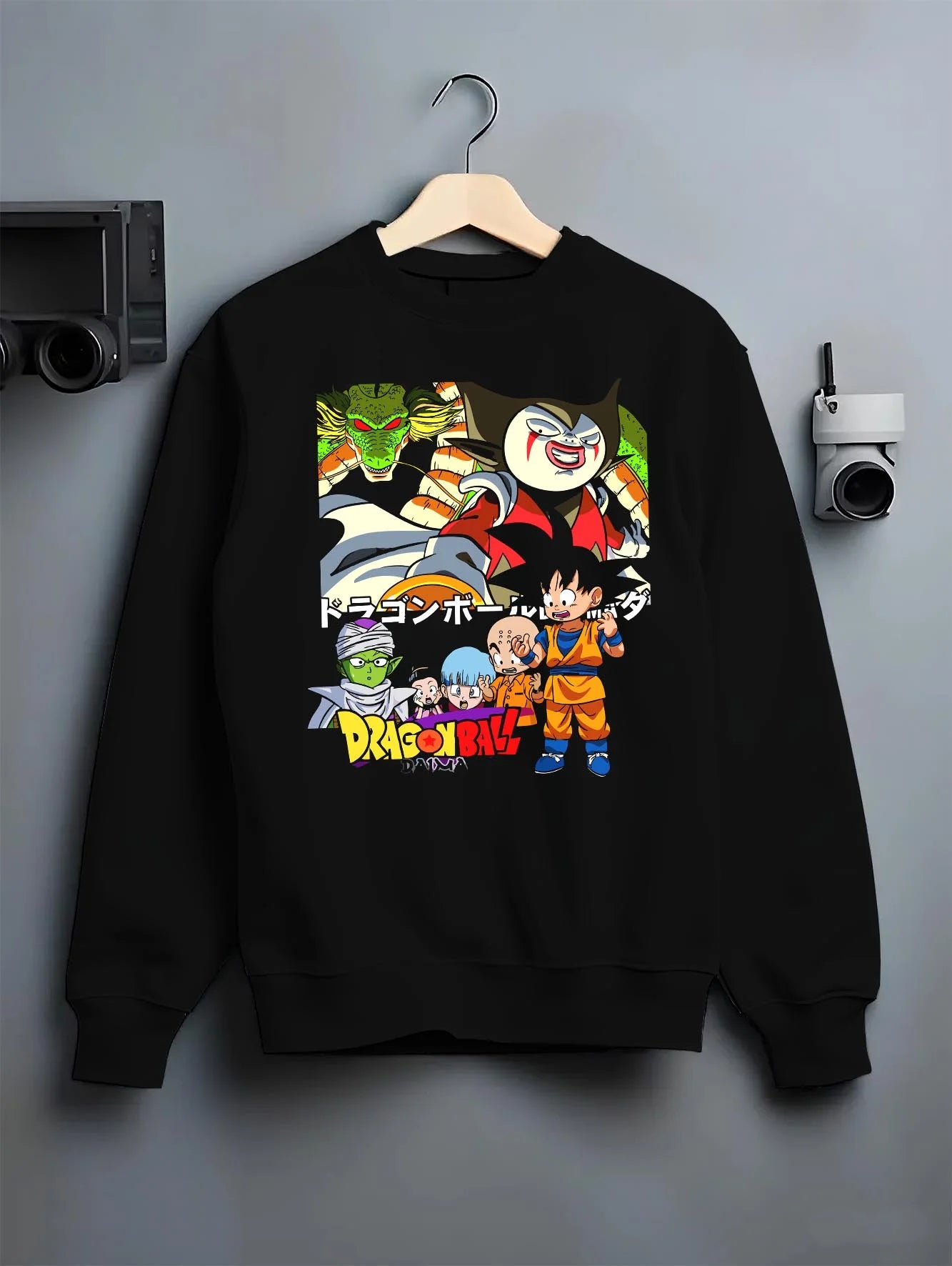 Black crewneck sweatshirt on hanger with Dragon Ball Daima Hoodie New World Anime Heroes graphic bold anime graphic.