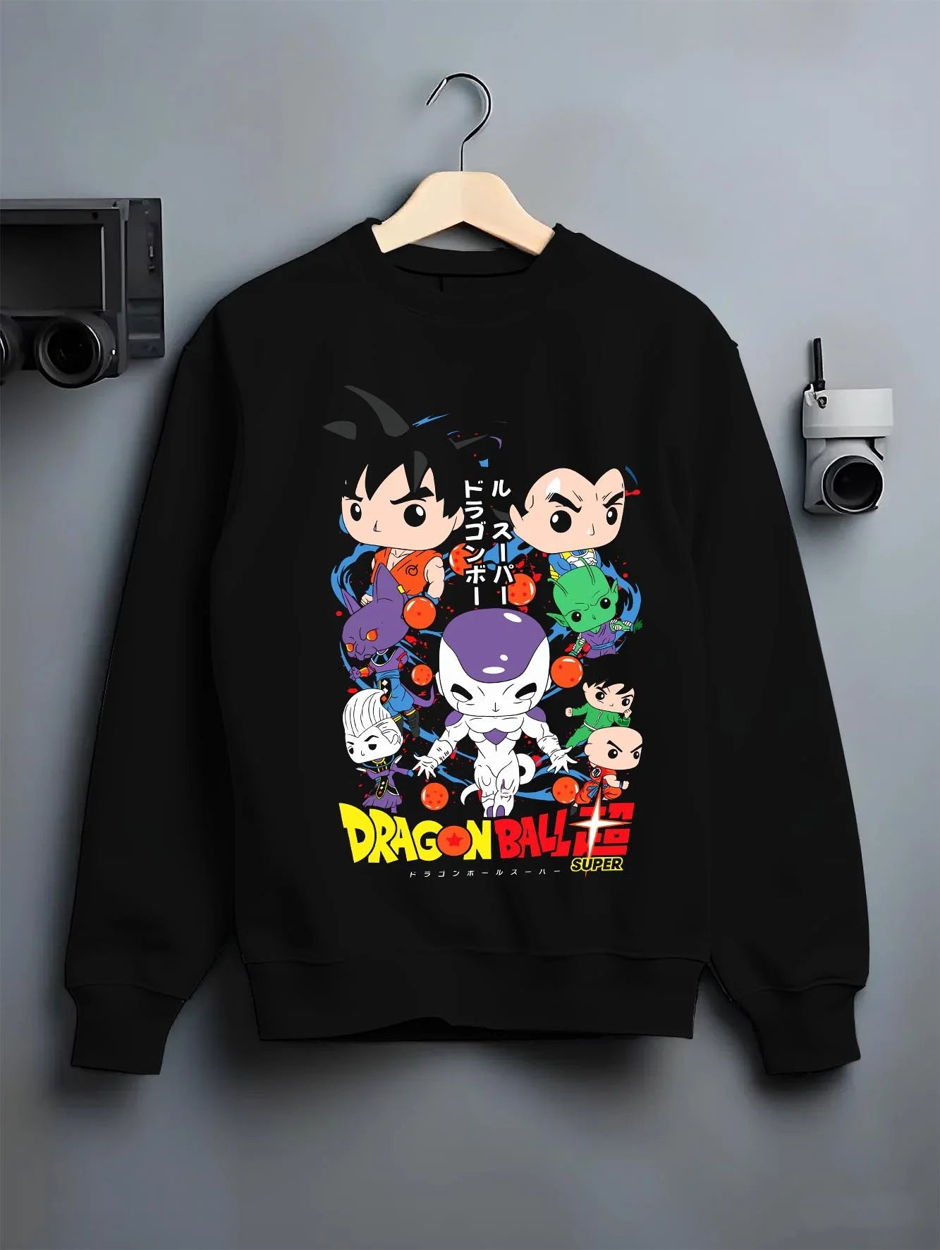 Black crewneck sweatshirt on hanger with Dragon Ball Hoodie Villains Retro Anime Poster Art graphic streetwear graphic.