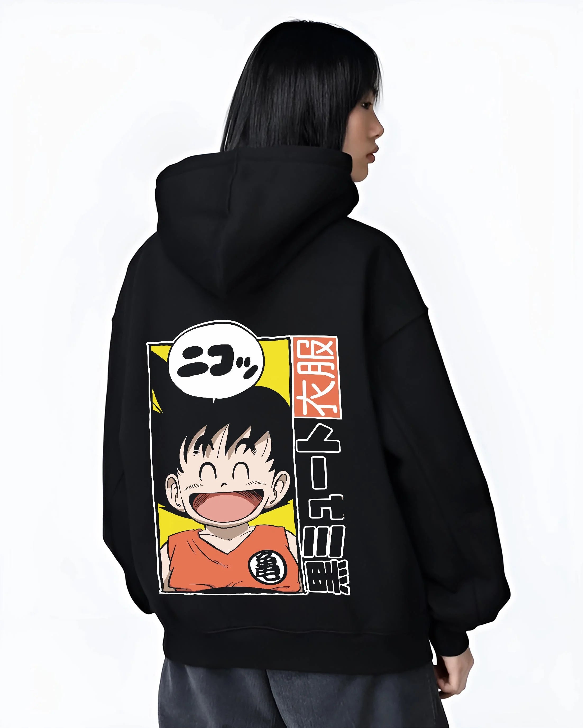 Black hoodie worn by female model, back view with Krillin Hoodie Dragon Ball Retro Nimbus Flying Pose graphic bold anime graphic.