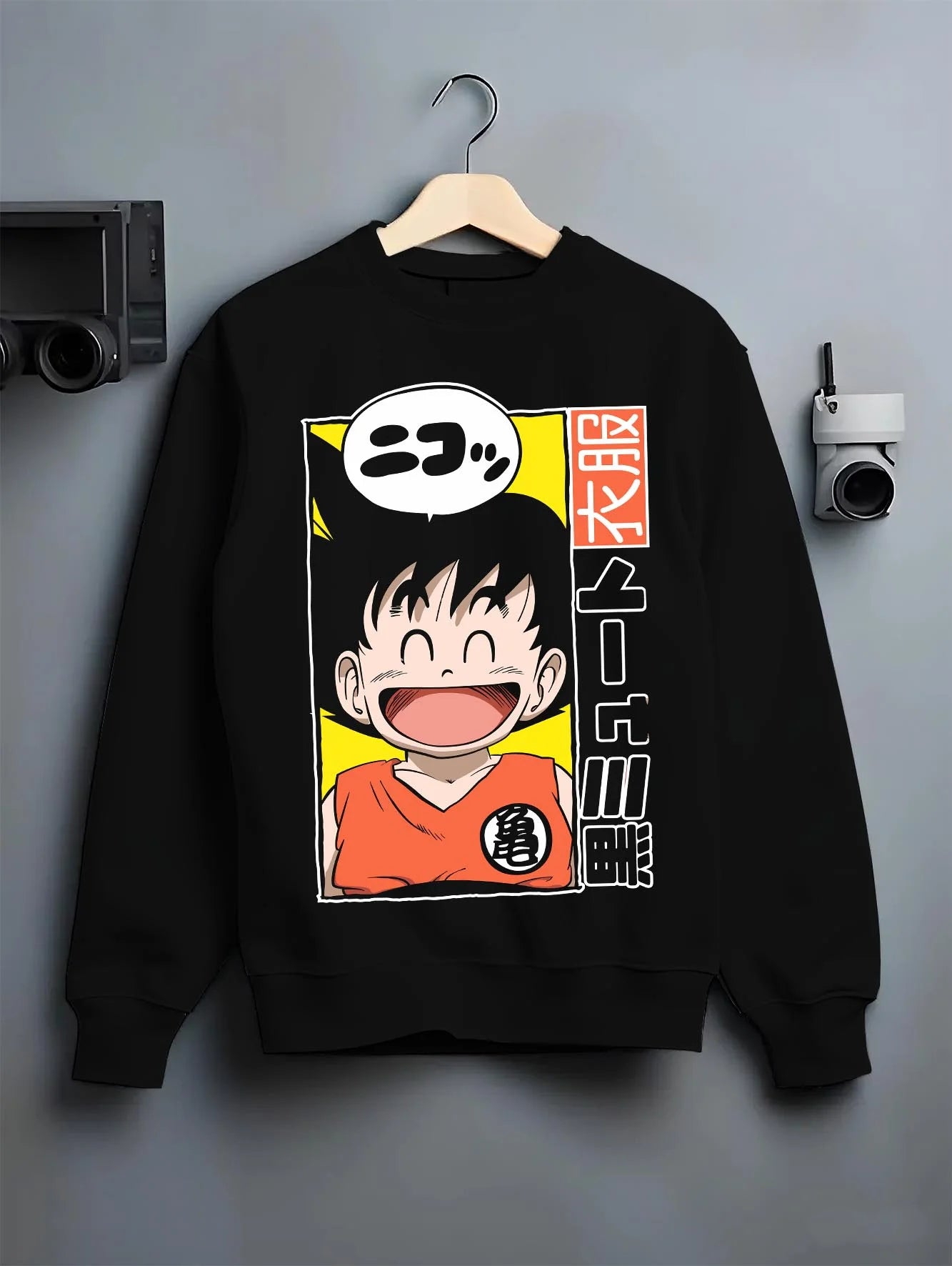 Black crewneck sweatshirt on hanger with Krillin Hoodie Dragon Ball Retro Nimbus Flying Pose graphic streetwear graphic.
