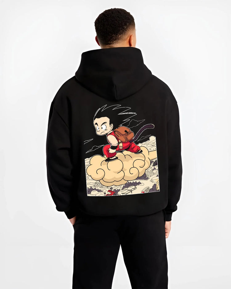 Black hoodie worn by male model, back view with Goku Hoodie Dragon Ball Kid Nimbus Cloud Adventure graphic bold anime graphic.