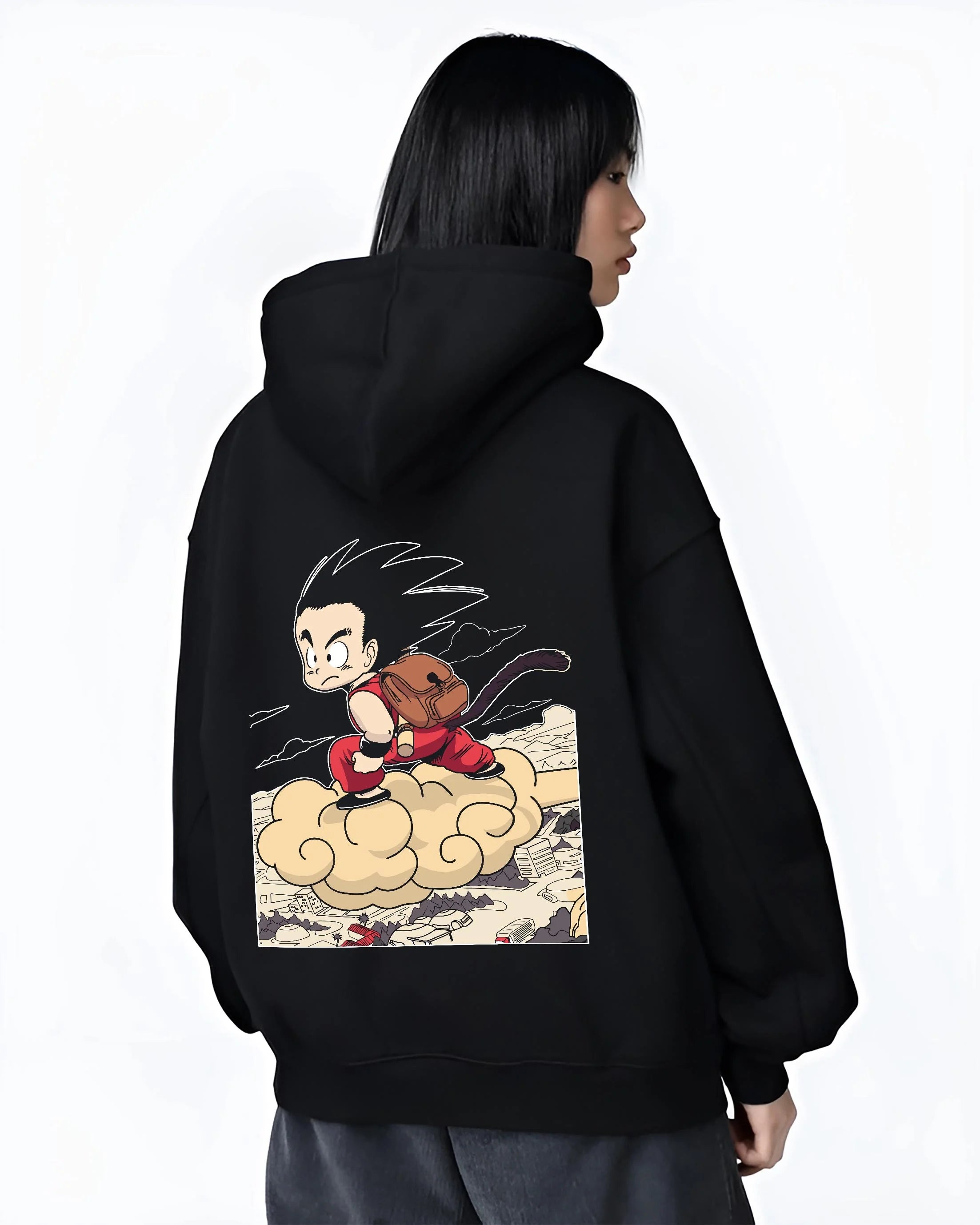 Black hoodie worn by female model, back view with Goku Hoodie Dragon Ball Kid Nimbus Cloud Adventure graphic streetwear graphic.