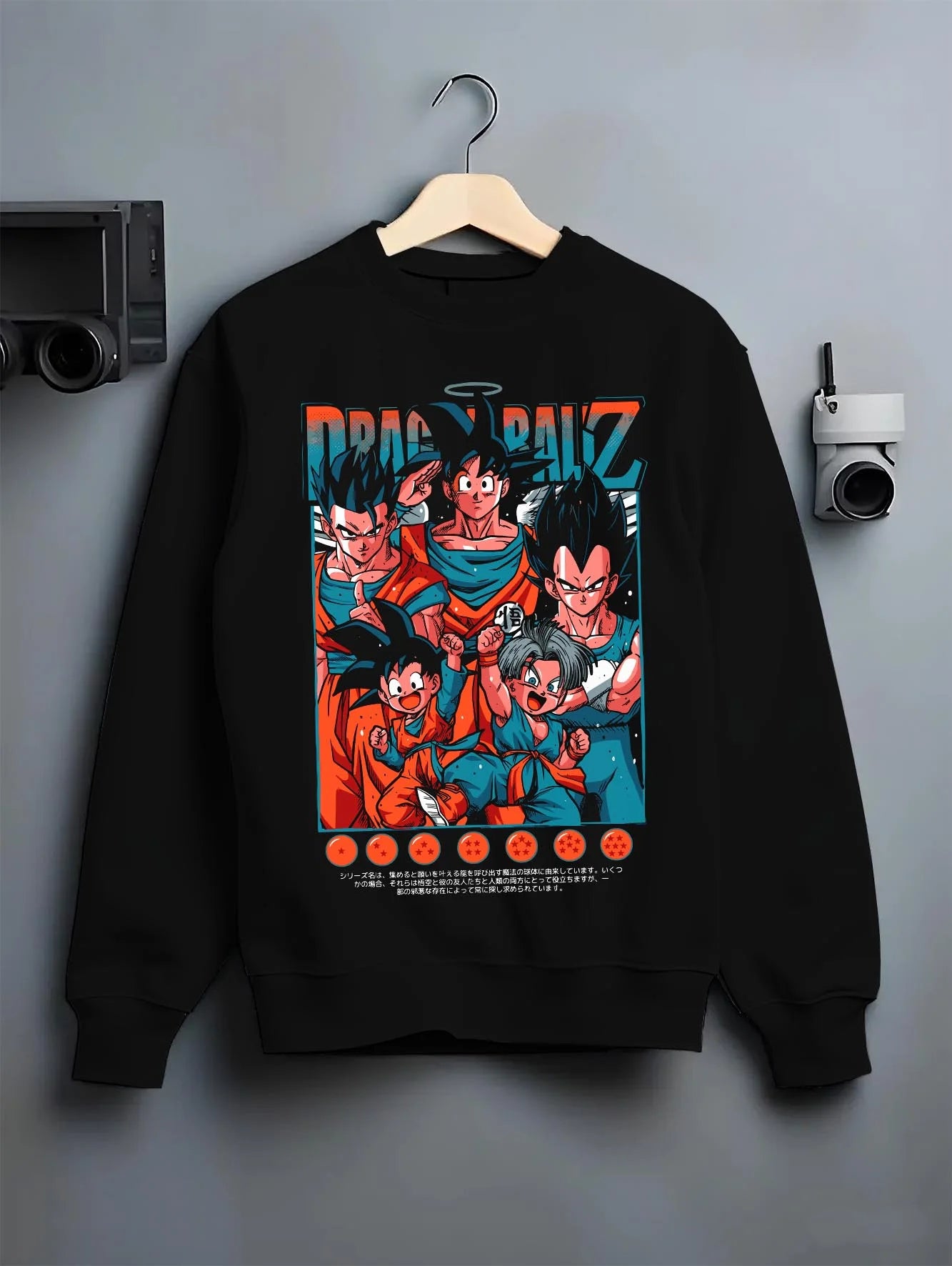 Black crewneck sweatshirt on hanger with Dragon Ball Hoodie Z Fighters Team Retro Collage graphic bold anime graphic.
