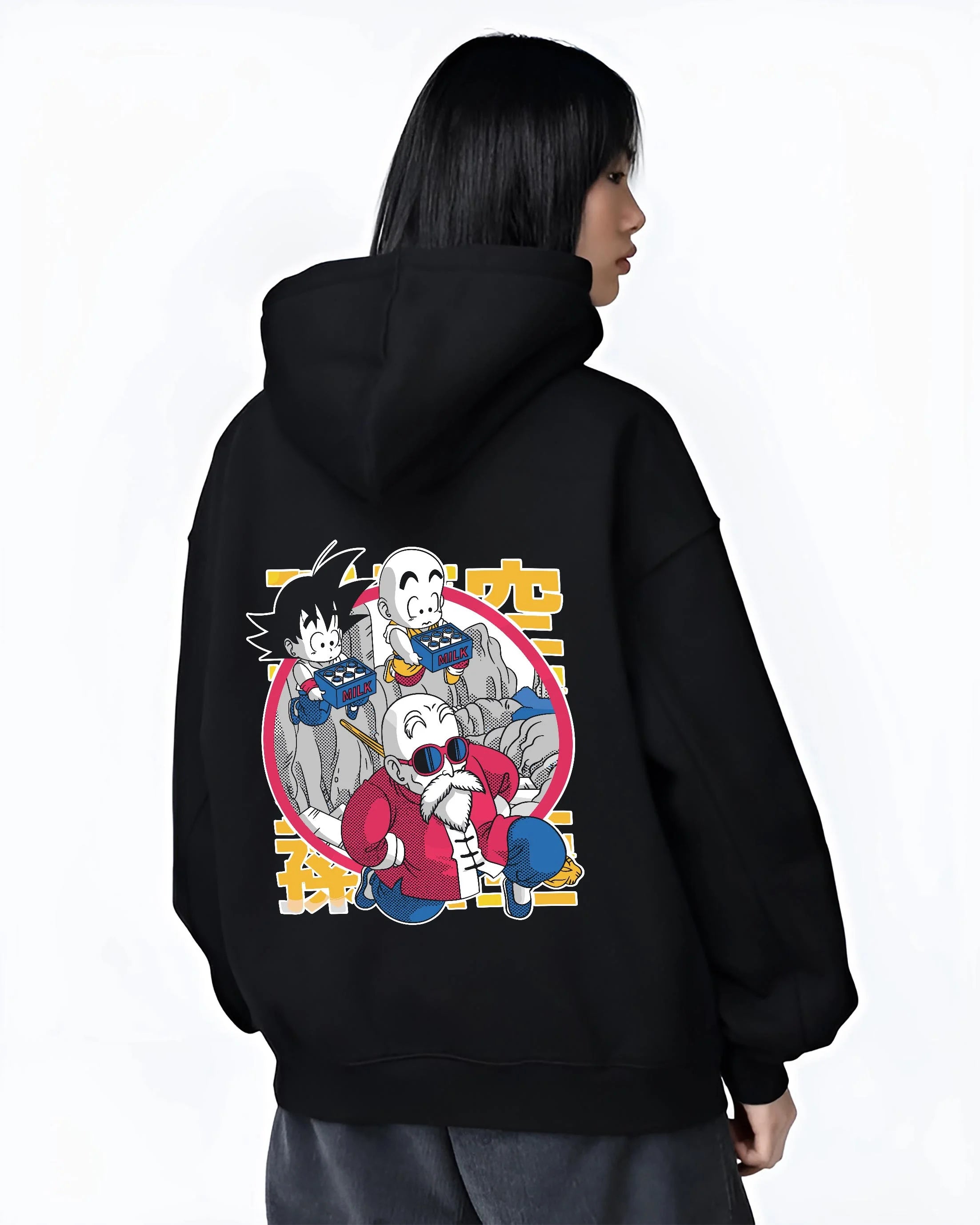 Black hoodie worn by female model, back view with Dragon Ball Hoodie Krillin Retro Training White Gi graphic premium wear.
