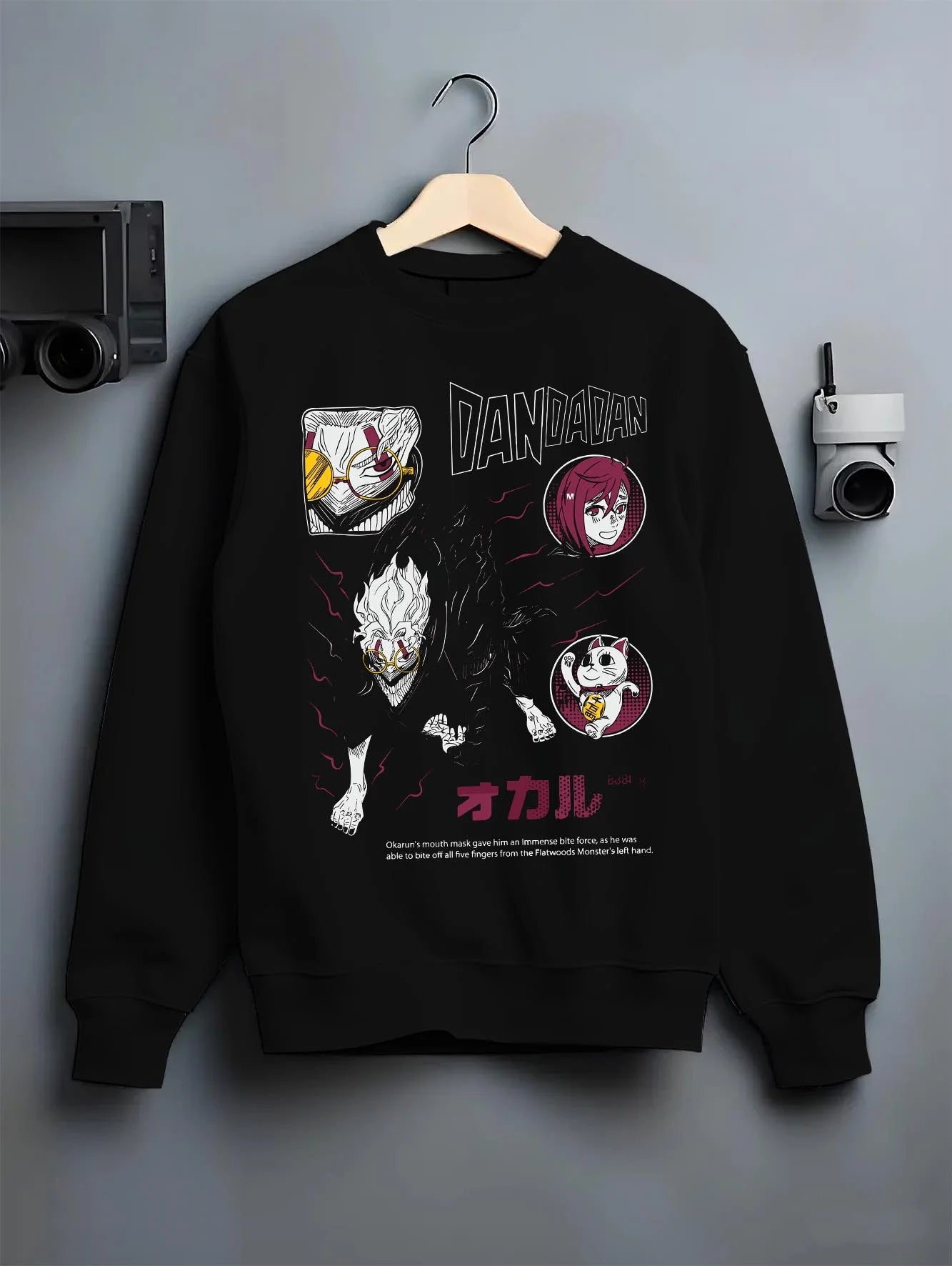 Black crewneck sweatshirt on hanger with Dandadan Hoodie Paranormal Battle Horror Retro Print graphic bold anime graphic.