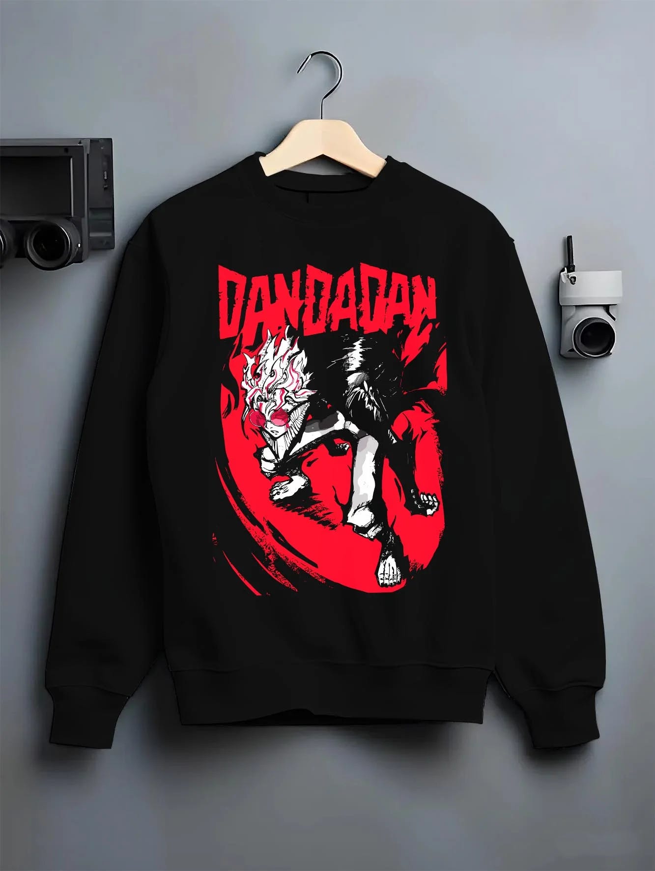 Black crewneck sweatshirt on hanger with Dandadan Hoodie Retro Anime Occult Spirit Adventure graphic streetwear graphic.