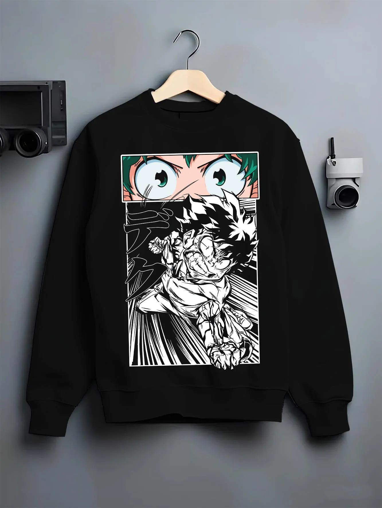 Black crewneck sweatshirt on hanger with Deku Hoodie My Hero Academia Dynamic Action Line Art graphic bold anime graphic.