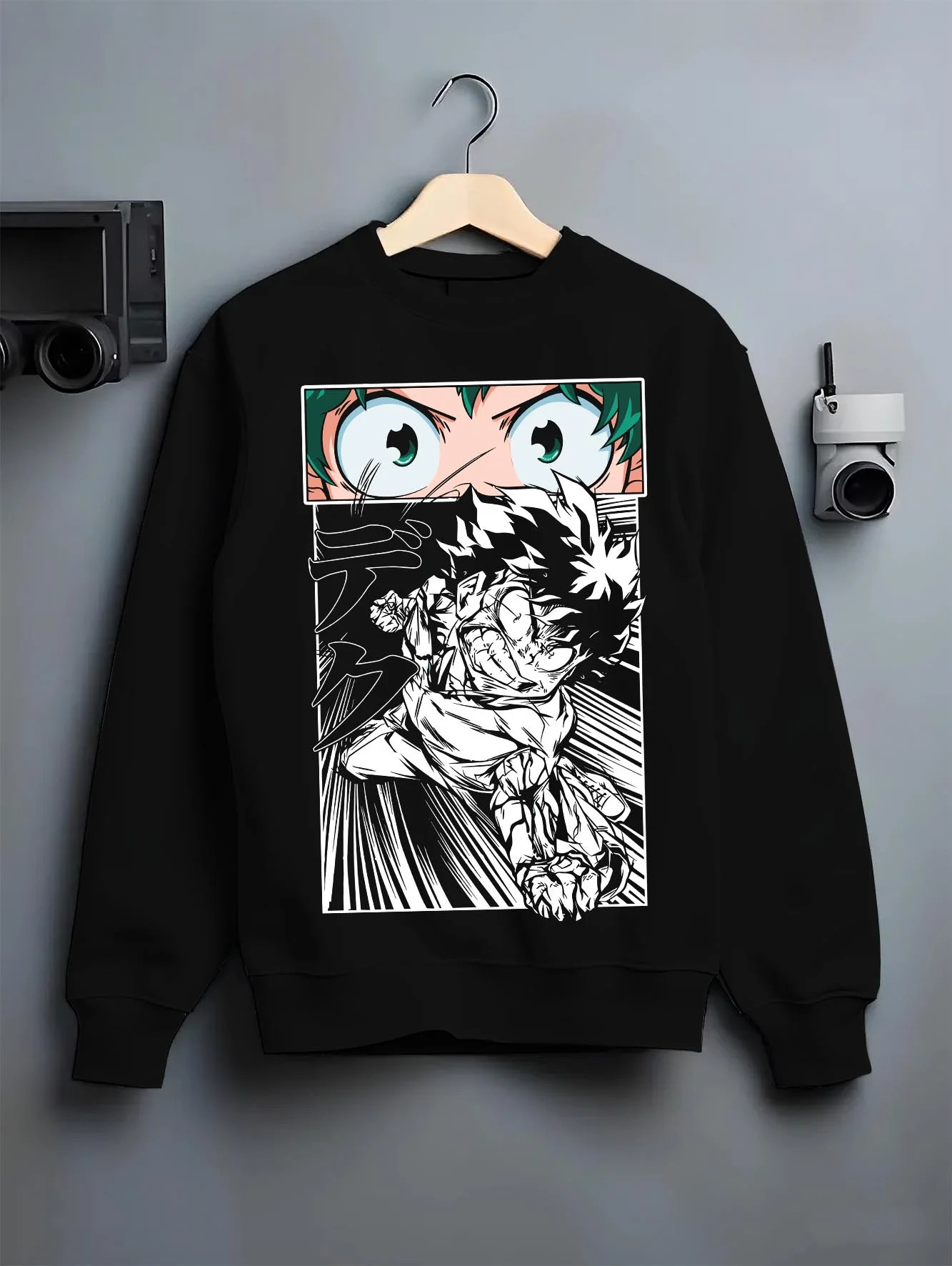 Black crewneck sweatshirt on hanger with Deku Hoodie My Hero Academia Dynamic Action Line Art graphic bold anime graphic.