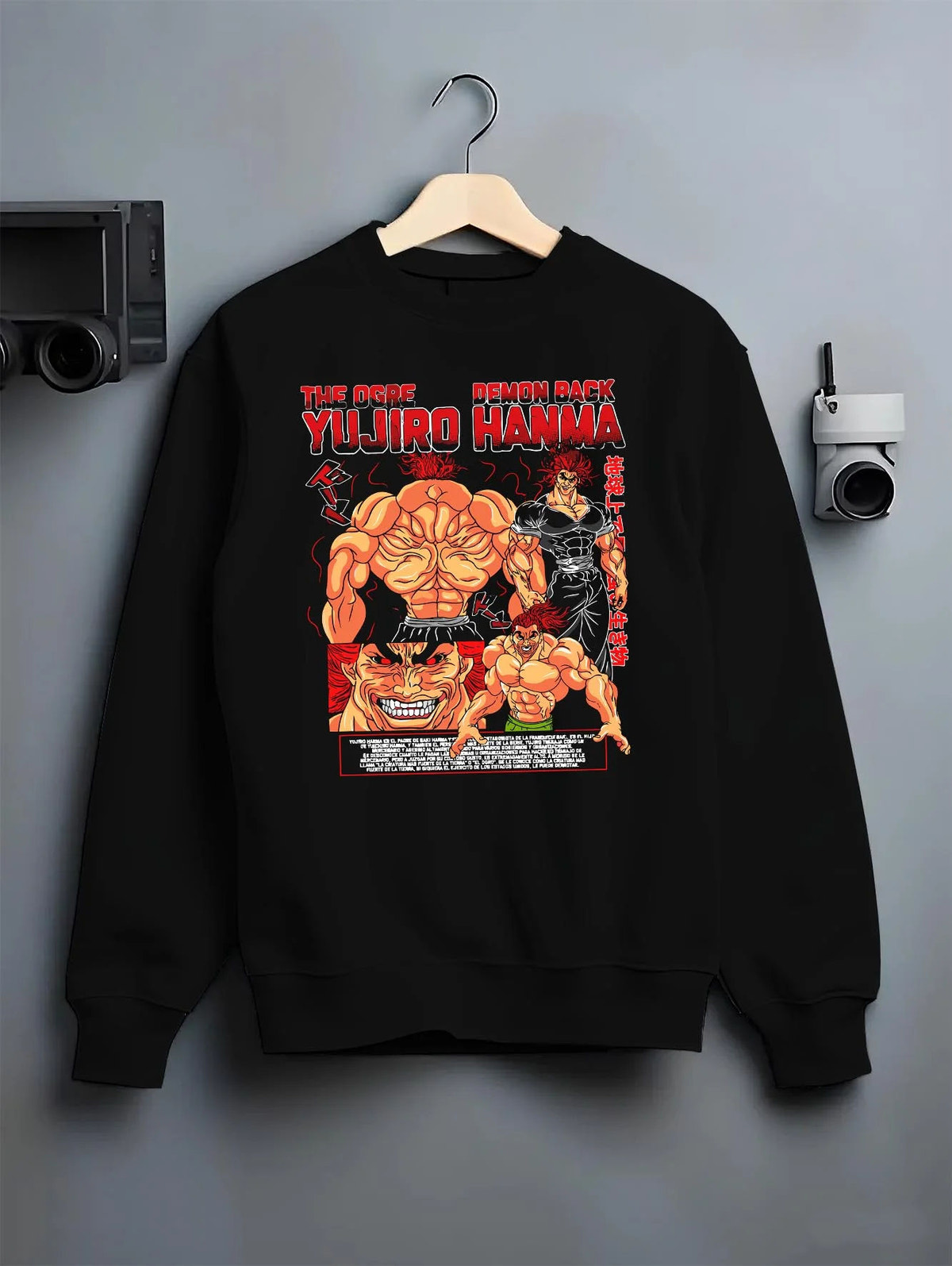 Black crewneck sweatshirt on hanger featuring Yujiro Hanma Baki demon back battle artwork.