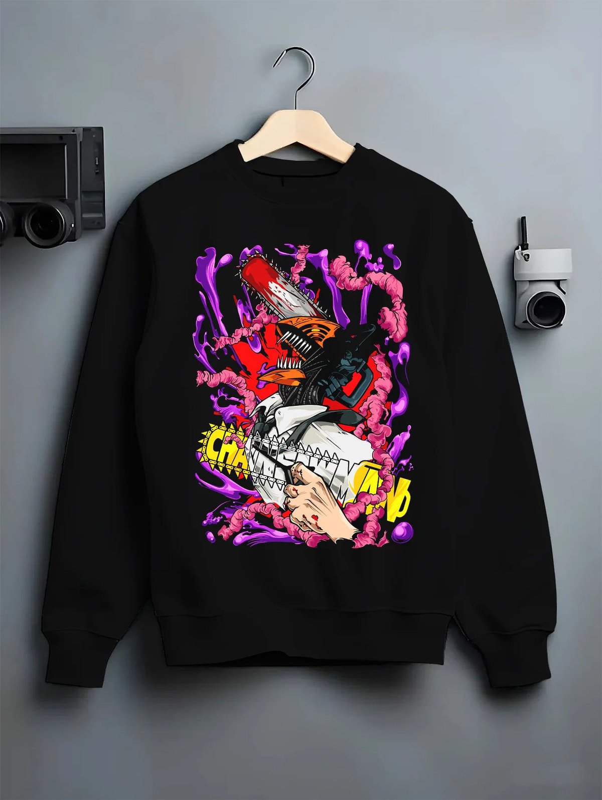 Black crewneck sweatshirt on hanger showing Denji transformed from Chainsaw Man: chainsaw face with purple devils