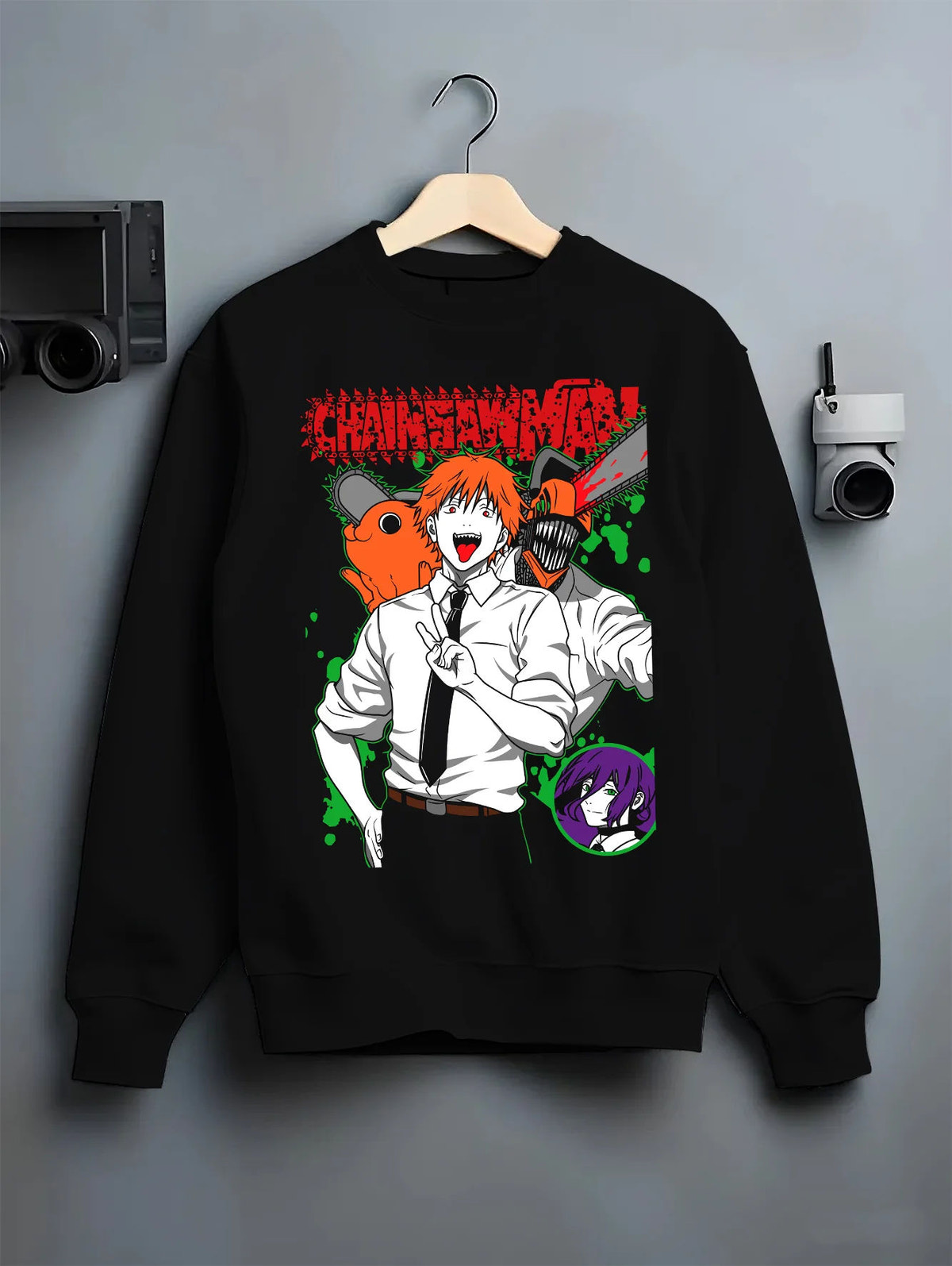 Black crewneck sweatshirt on hanger showing Denji (human form) and Pochita from Chainsaw Man: orange-green illustration
