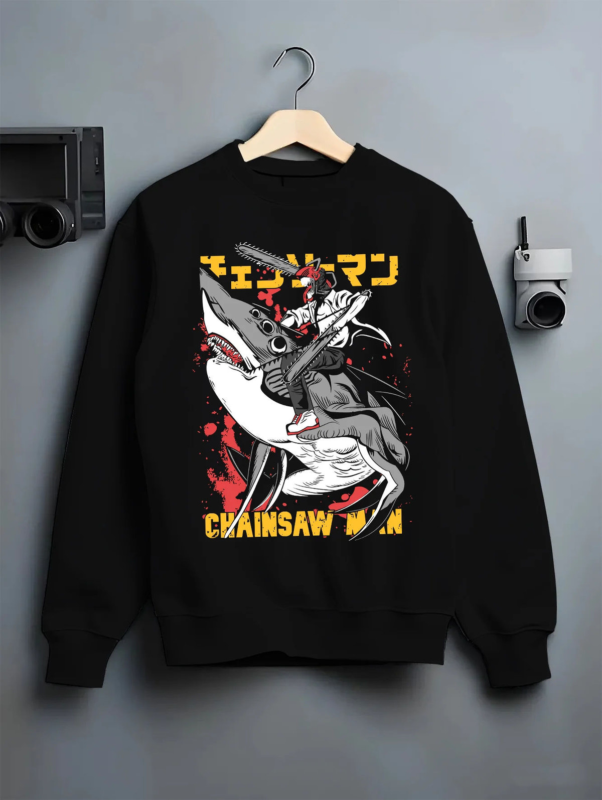 Black crewneck sweatshirt on hanger showing Chainsaw Devil / Denji from Chainsaw Man: graphic chainsaw-mouth attack