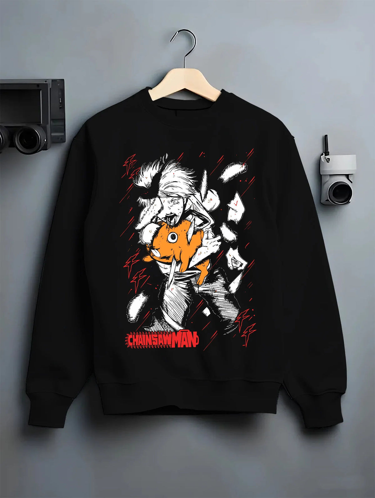 Black crewneck sweatshirt on hanger showing Denji and Pochita from Chainsaw Man: manga-style cute chainsaw face