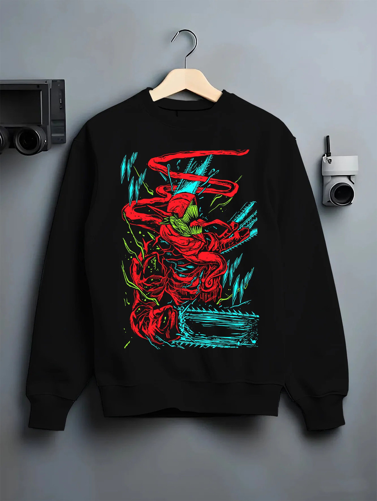 Black crewneck sweatshirt on hanger showing Chainsaw Devil from Chainsaw Man: red/green abstract fighting pose