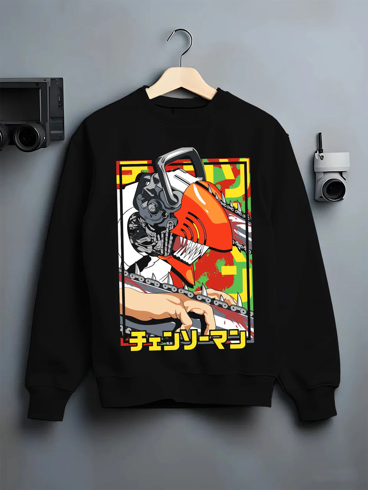 Black crewneck sweatshirt on hanger showing Chainsaw Devil / Denji from Chainsaw Man: orange mechanical saw-head pose