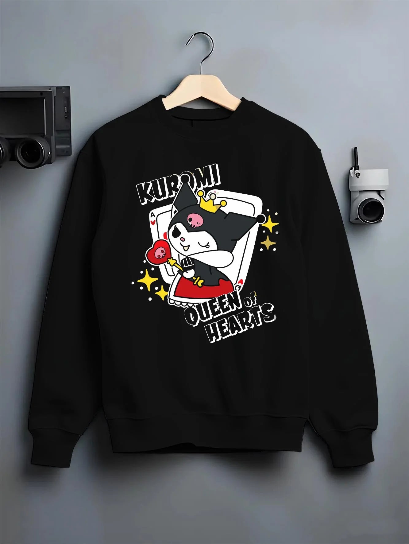 Black crewneck sweatshirt on hanger with Sanrio Kuromi Hoodie Queen of Hearts Cute Jumper graphic bold anime graphic.