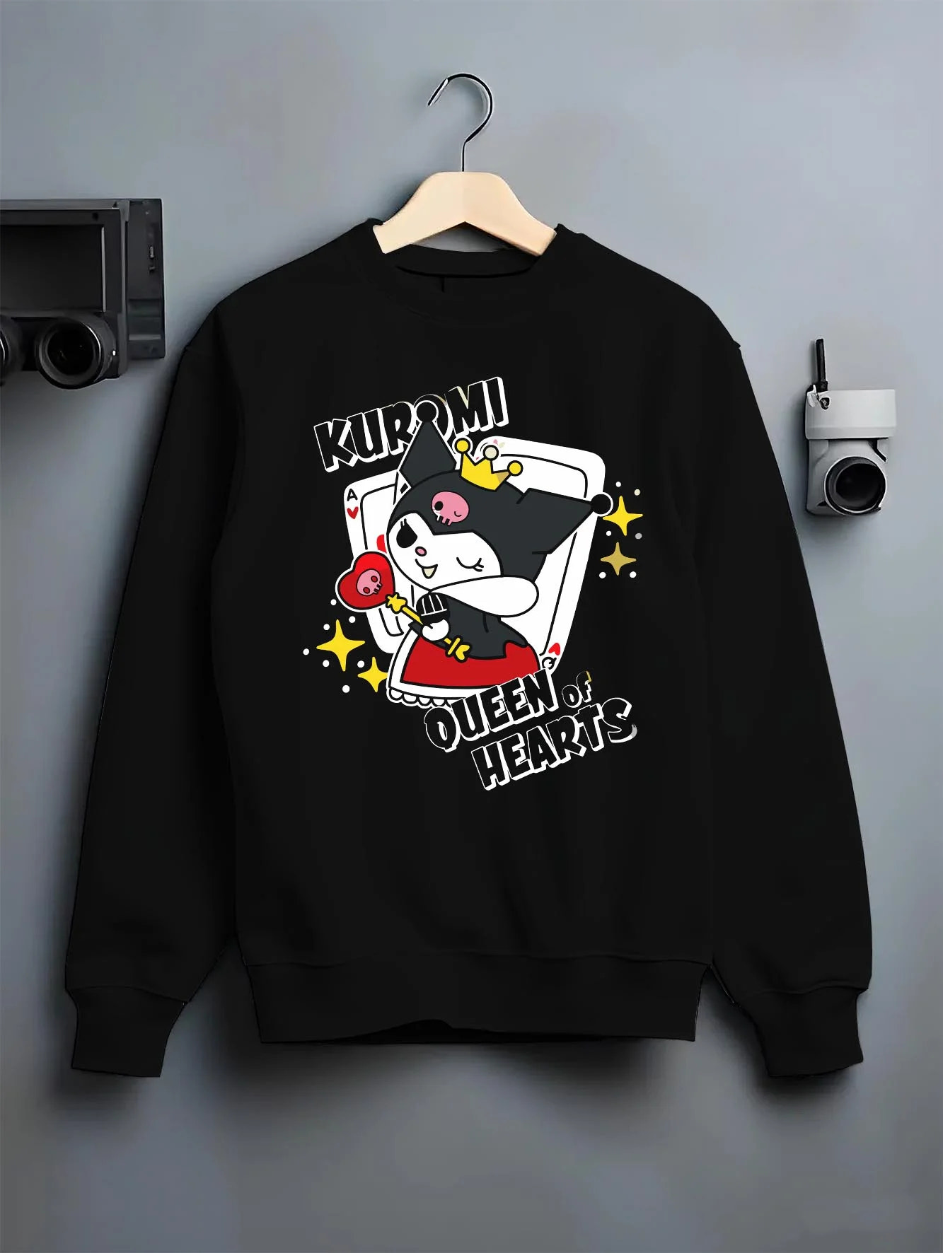 Black crewneck sweatshirt on hanger with Sanrio Kuromi Hoodie Queen of Hearts Cute Jumper graphic bold anime graphic.