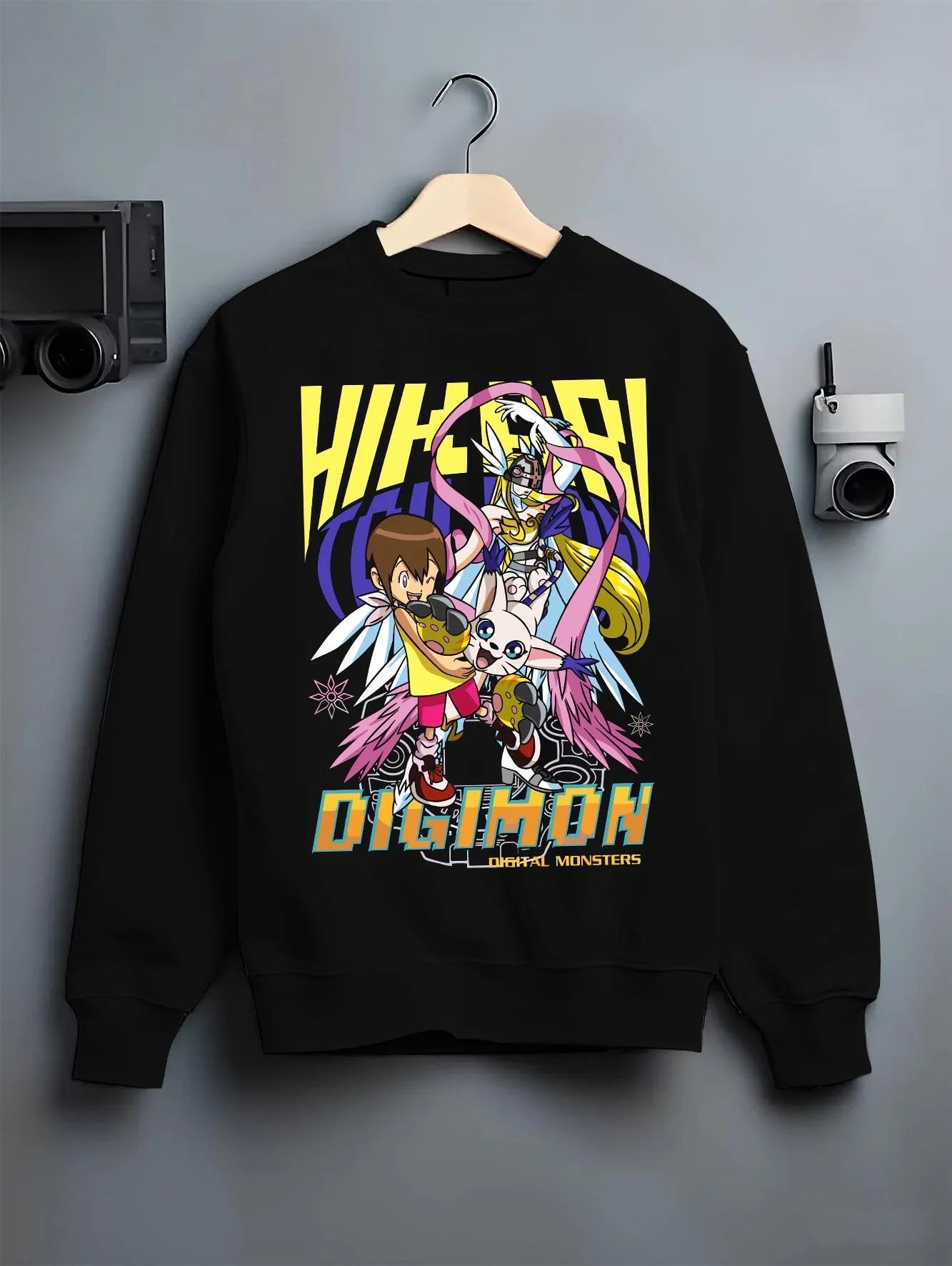Black crewneck sweatshirt on hanger with Digimon Hoodie Kari with Gatomon Retro Partner Print graphic bold anime graphic.
