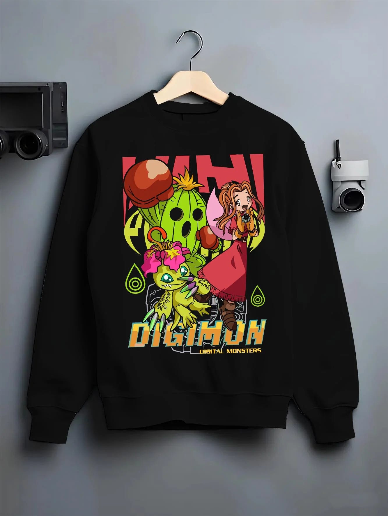 Black crewneck sweatshirt on hanger with Digimon Hoodie Mimi with Palmon Retro Partner Print graphic premium wear.