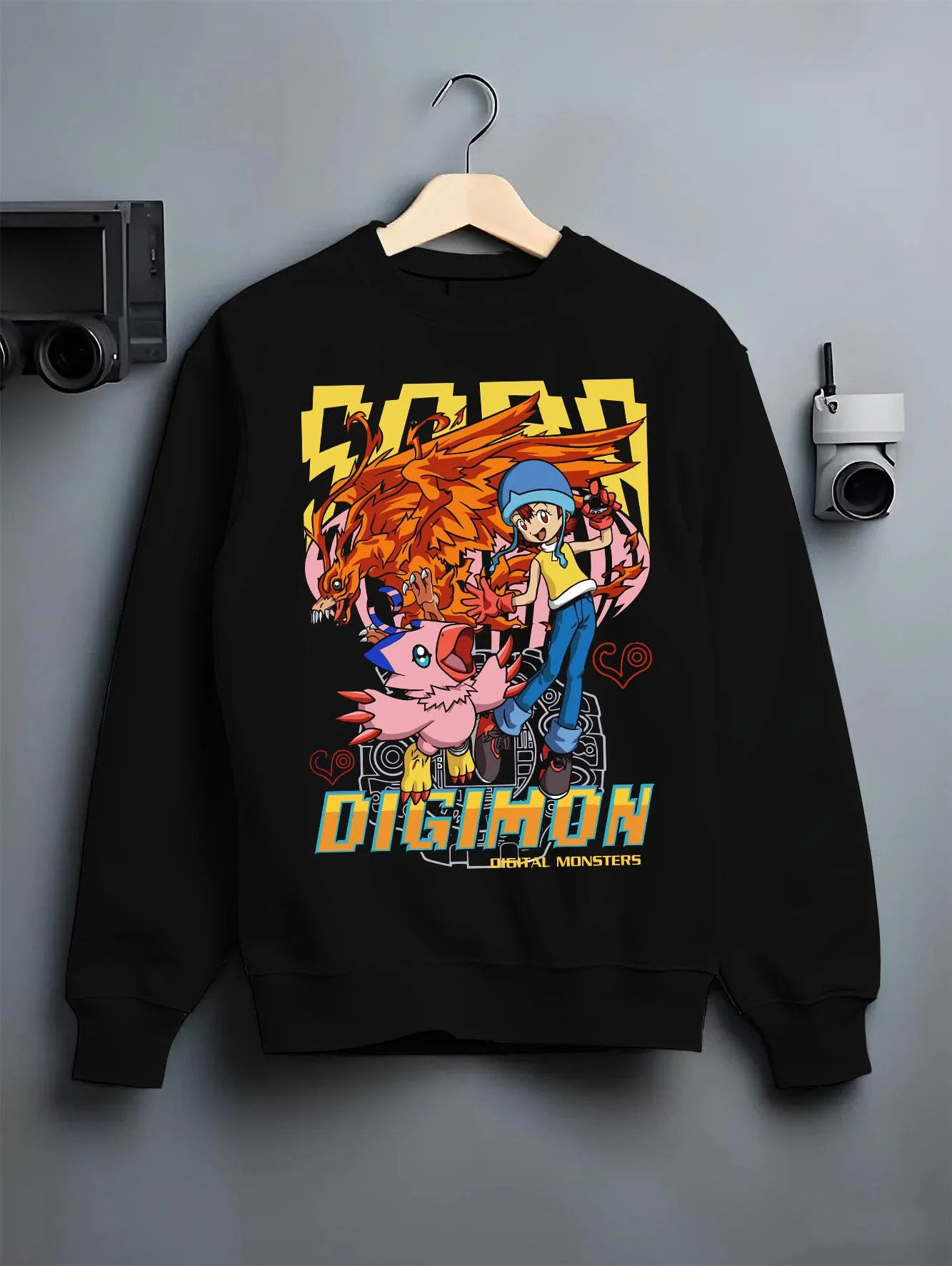 Black crewneck sweatshirt on hanger with Digimon Hoodie Sora with Biyomon Retro Partner Print graphic streetwear graphic.