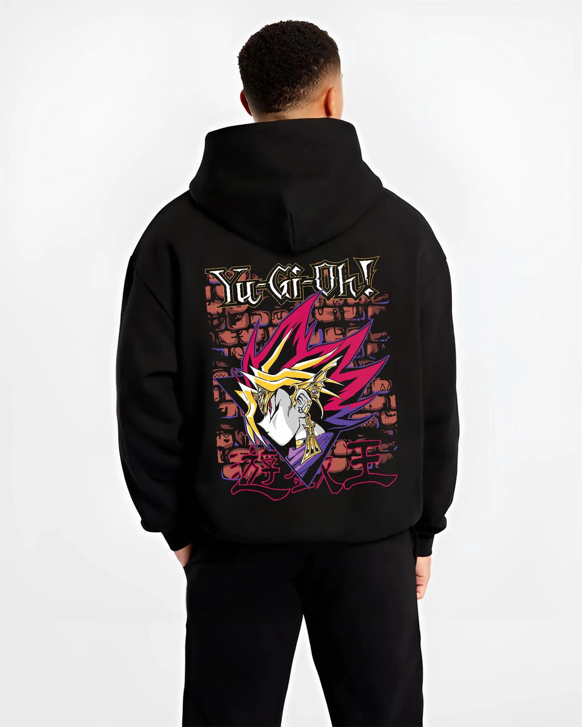 Black hoodie worn by male model from the back featuring Dark Magician Yu-Gi-Oh duel monster artwork.