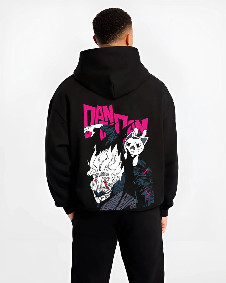 Black hoodie worn by male model, back view with Dandadan Hoodie Hero Transformation Retro Anime Art graphic bold anime graphic.