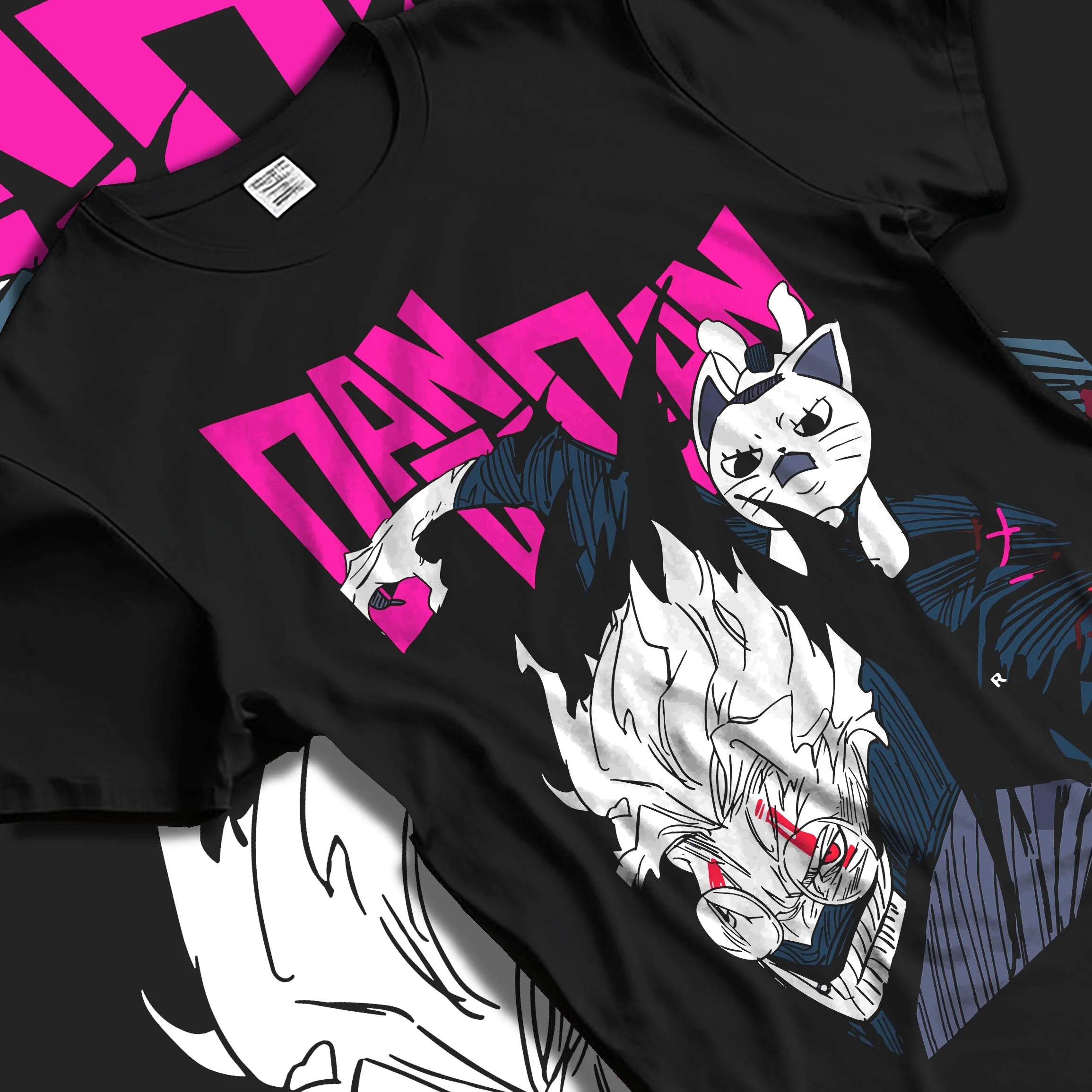 Black T-shirt laid flat with natural folds with Dandadan Hoodie Hero Transformation Retro Anime Art graphic bold anime graphic.