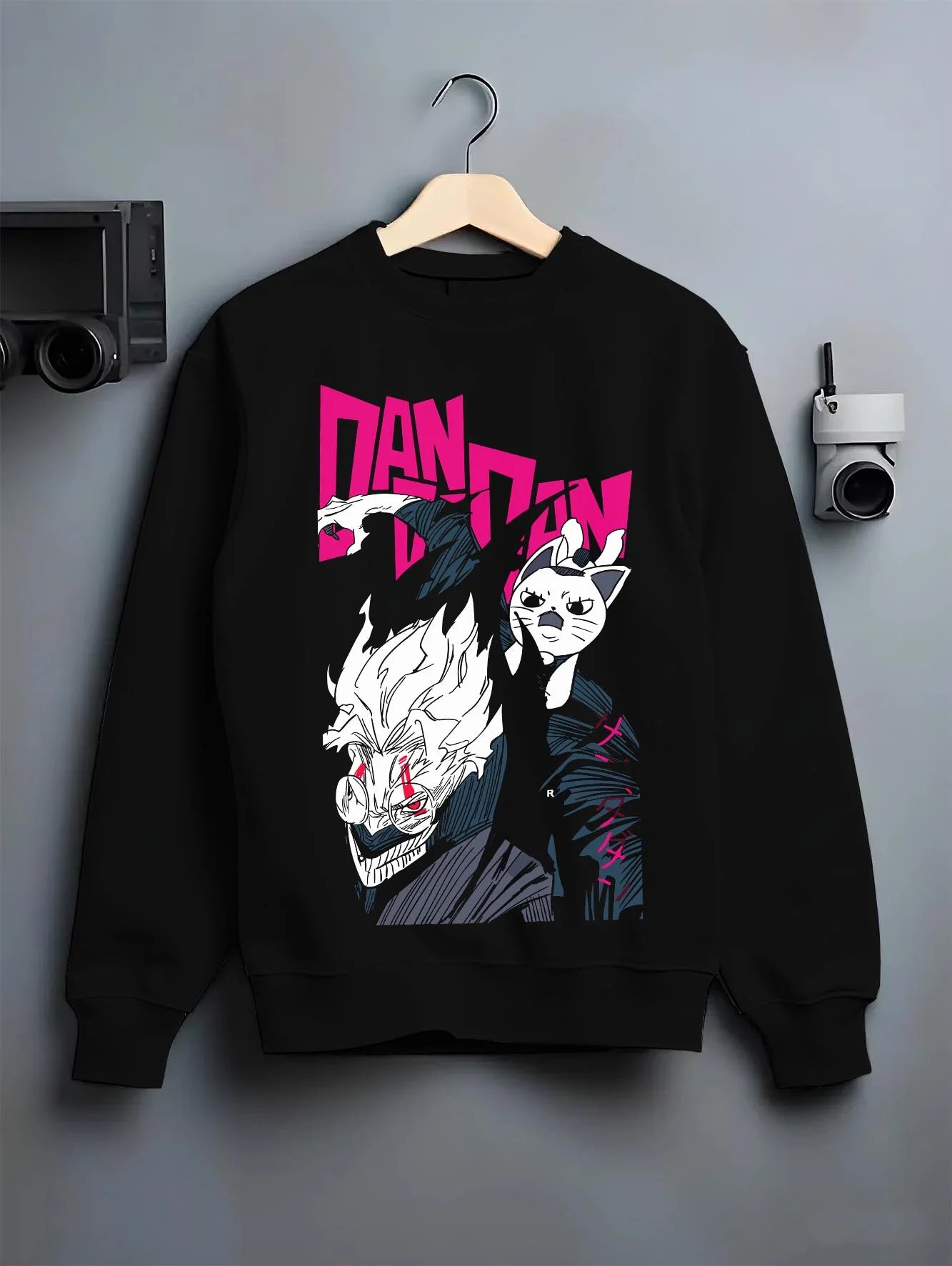 Black crewneck sweatshirt on hanger with Dandadan Hoodie Hero Transformation Retro Anime Art graphic Okarun anime design.
