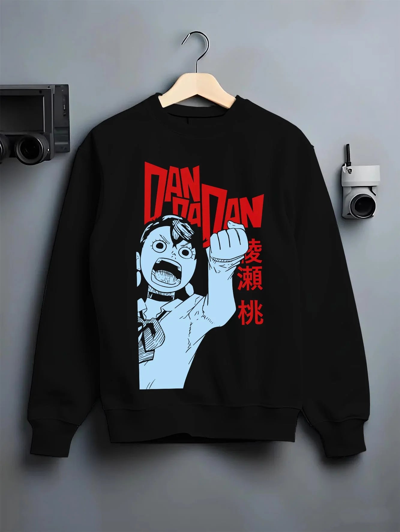 Black crewneck sweatshirt on hanger with Dandadan Hoodie Momo Ayase Paranormal Retro Poster graphic bold anime graphic.
