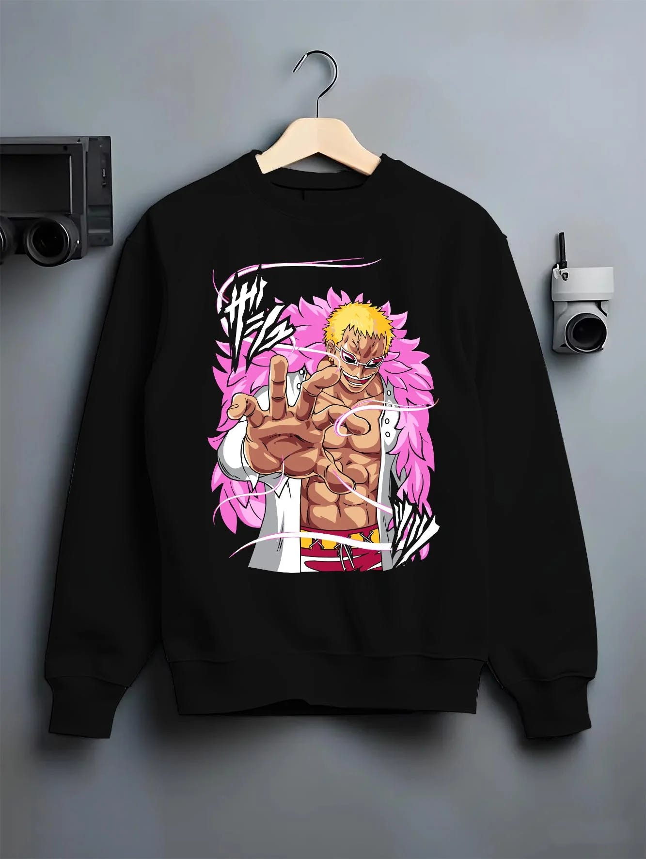 Black crewneck sweatshirt on hanger with Doflamingo Hoodie One Piece Villain Charisma Poster graphic bold anime graphic.