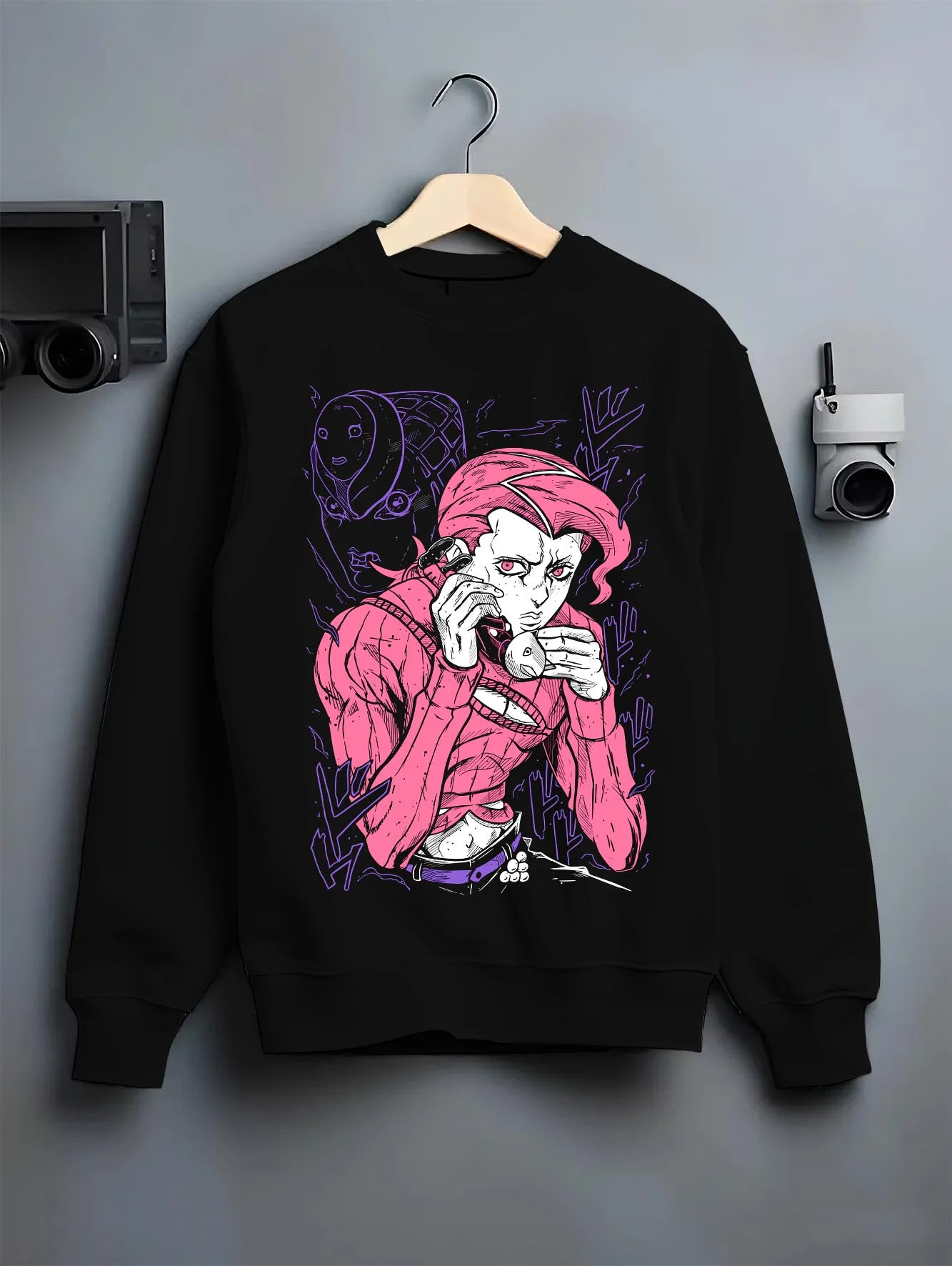 Black crewneck sweatshirt on hanger with JoJo Hoodie Dio Brando JoJo’s Bizarre Adventure Art graphic premium wear.
