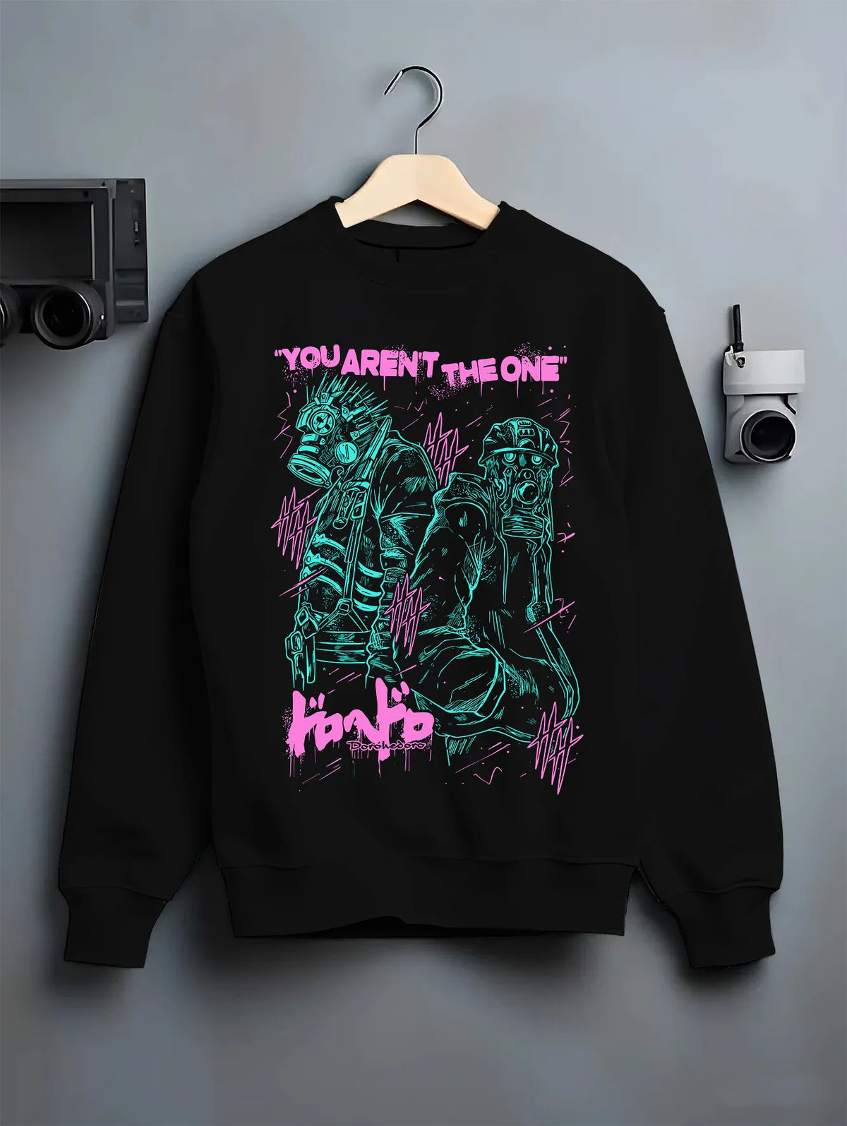 Black crewneck sweatshirt on hanger showing Dorohedoro: neon grotesque character duo
