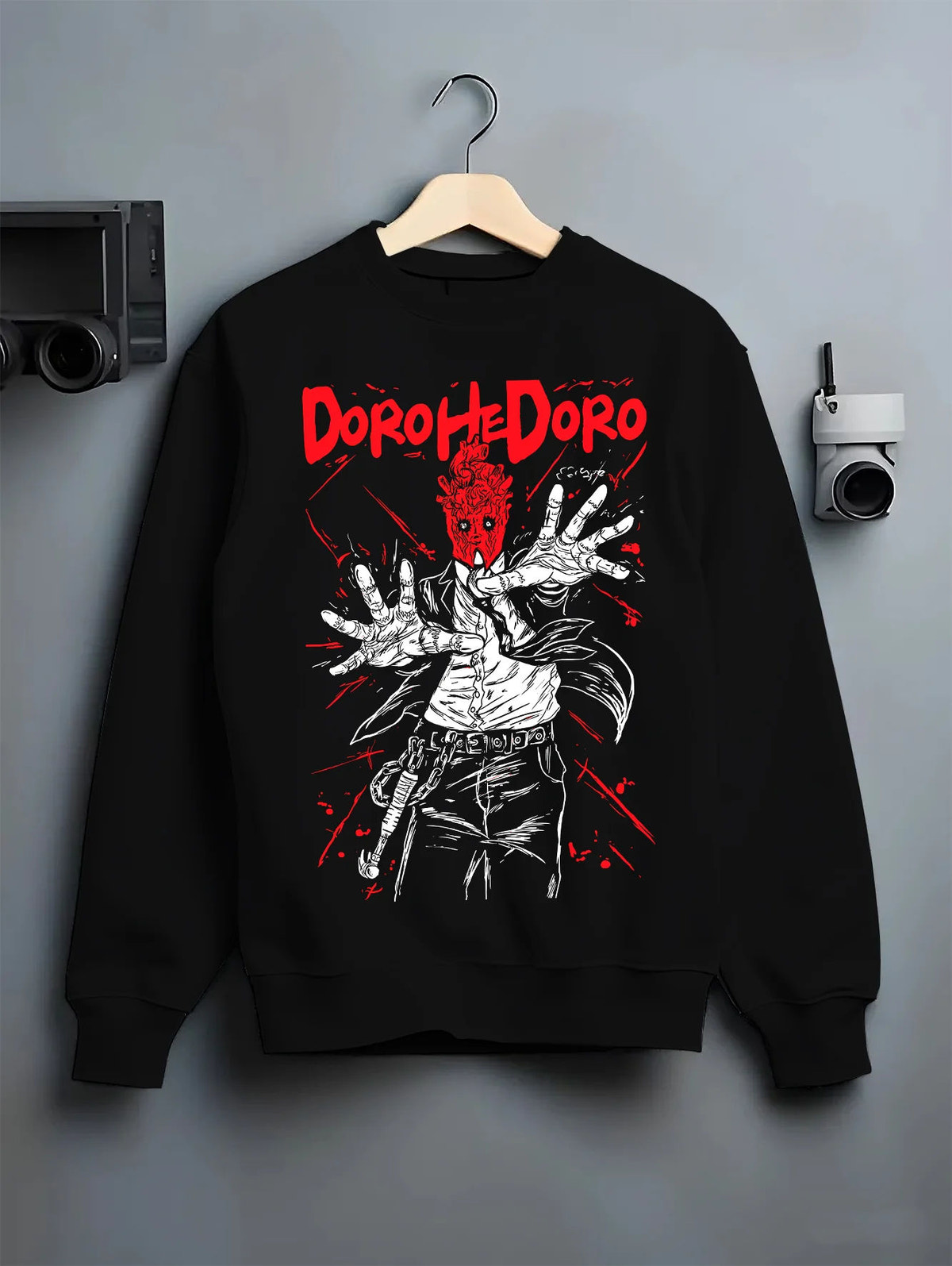Black crewneck sweatshirt on hanger showing Dorohedoro: Caiman/character red hand illustration