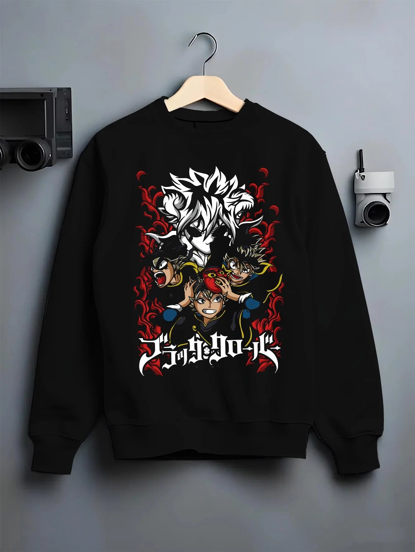 Black crewneck sweatshirt on hanger with Asta Hoodie Black Clover Trio Retro Anime Poster graphic streetwear graphic.
