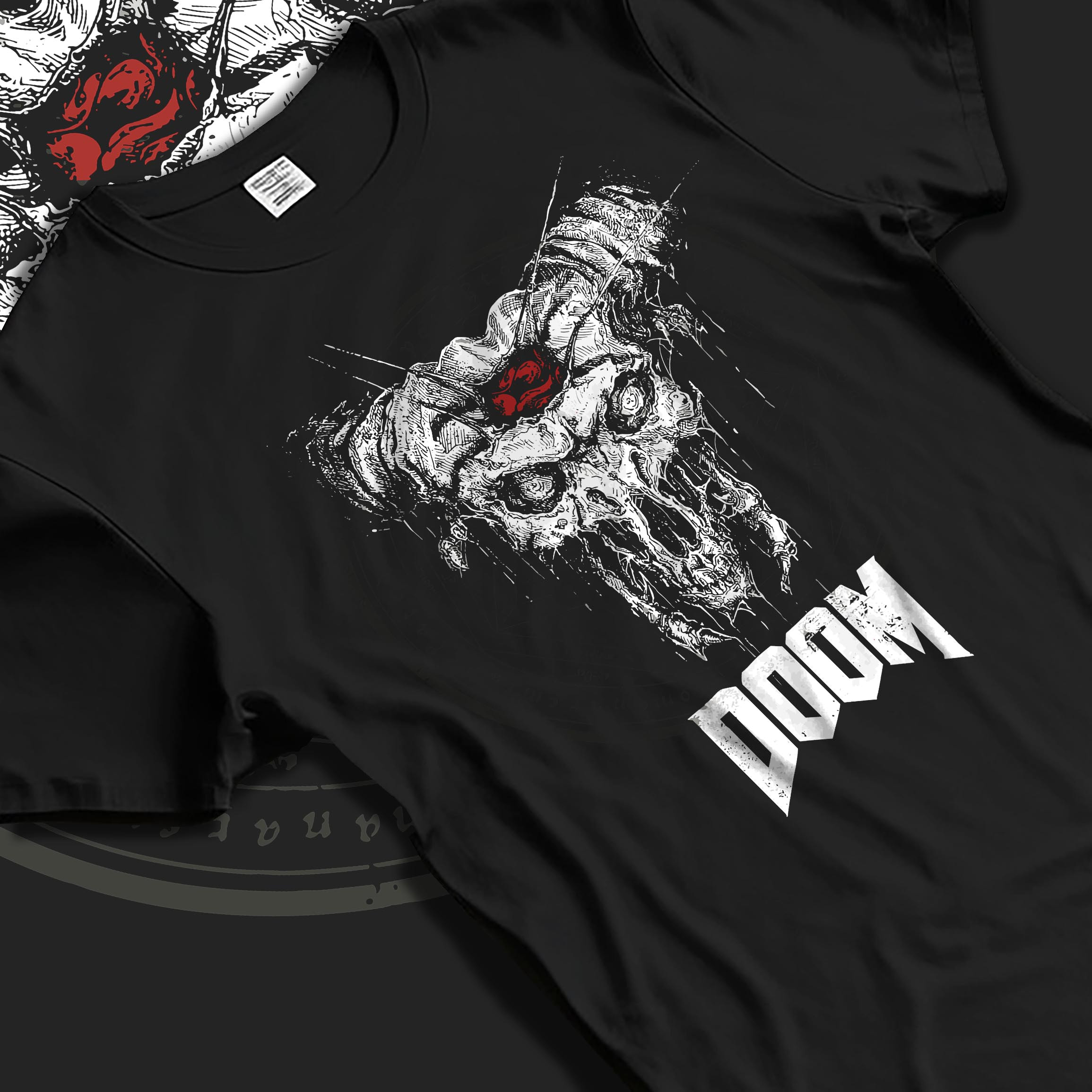Black T-shirt laid flat with natural fabric folds, featuring DOOM demonic skull graphic with horns, distressed horror design and apocalyptic retro style.