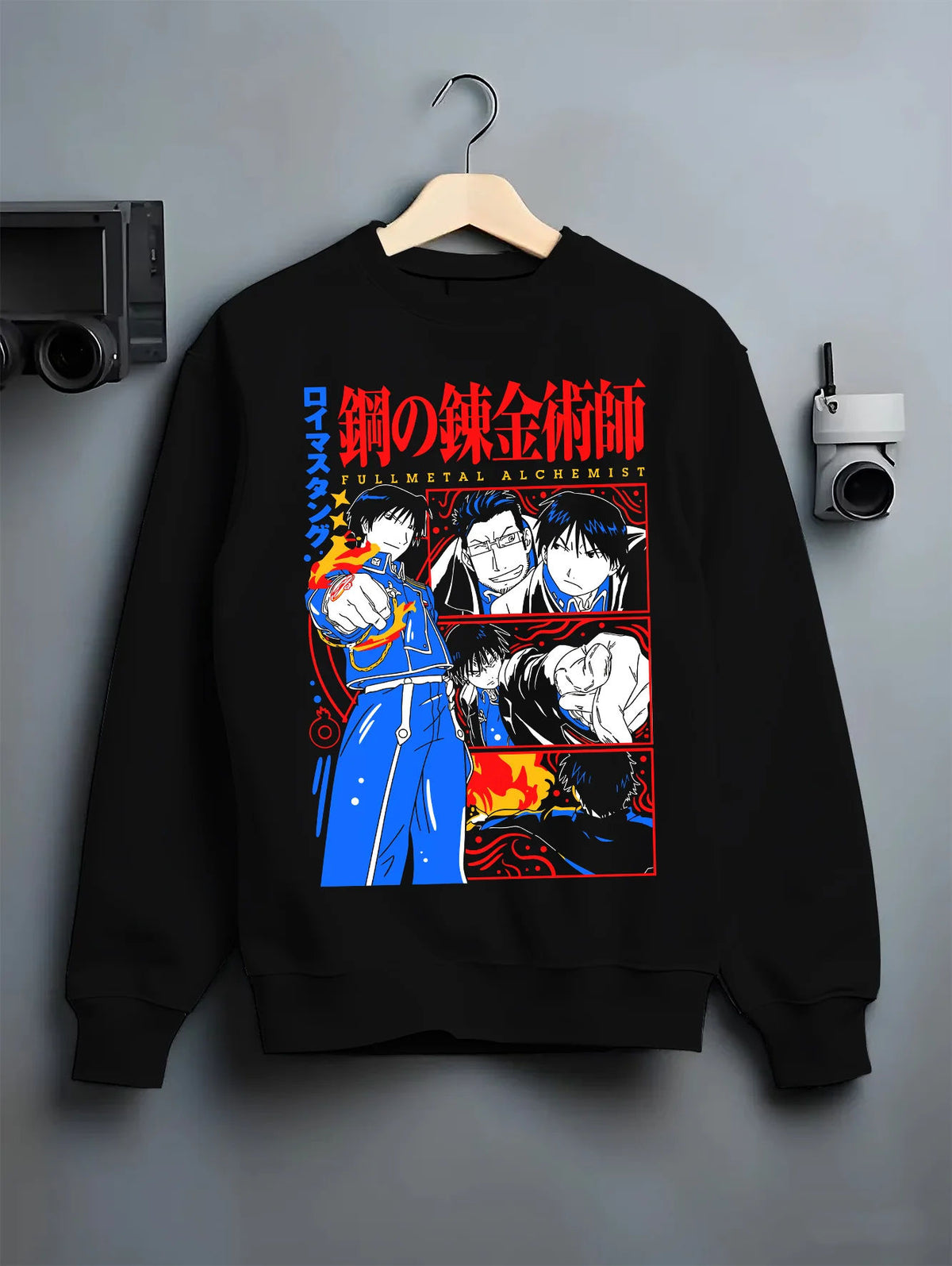 Black crewneck sweatshirt on hanger with Edward Elric / Fullmetal Alchemist ensemble illustrated back graphic