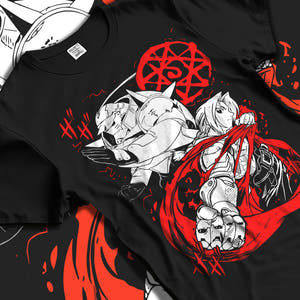 Black T-shirt laid flat with natural fabric folds, featuring Edward and Alphonse Fullmetal Alchemist anime poster inspired design with dramatic red alchemy circle and manga artwork.