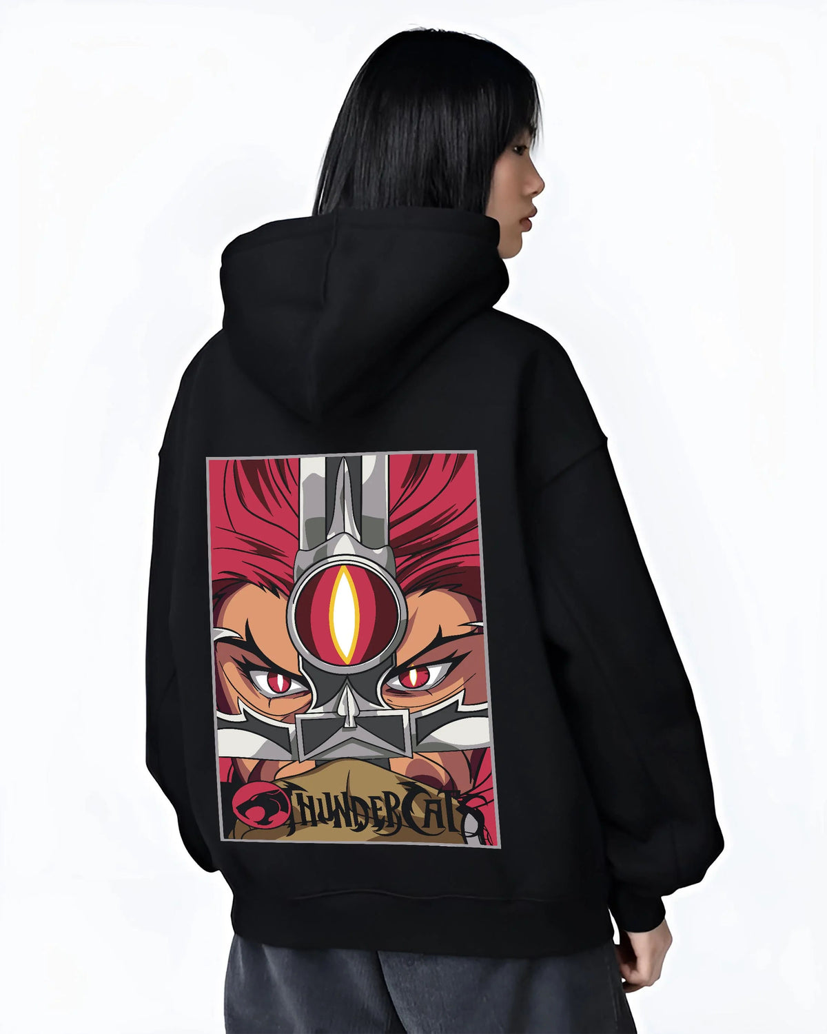 Black hoodie worn by female model from the back featuring Thundercats Eye of Thundera artwork.